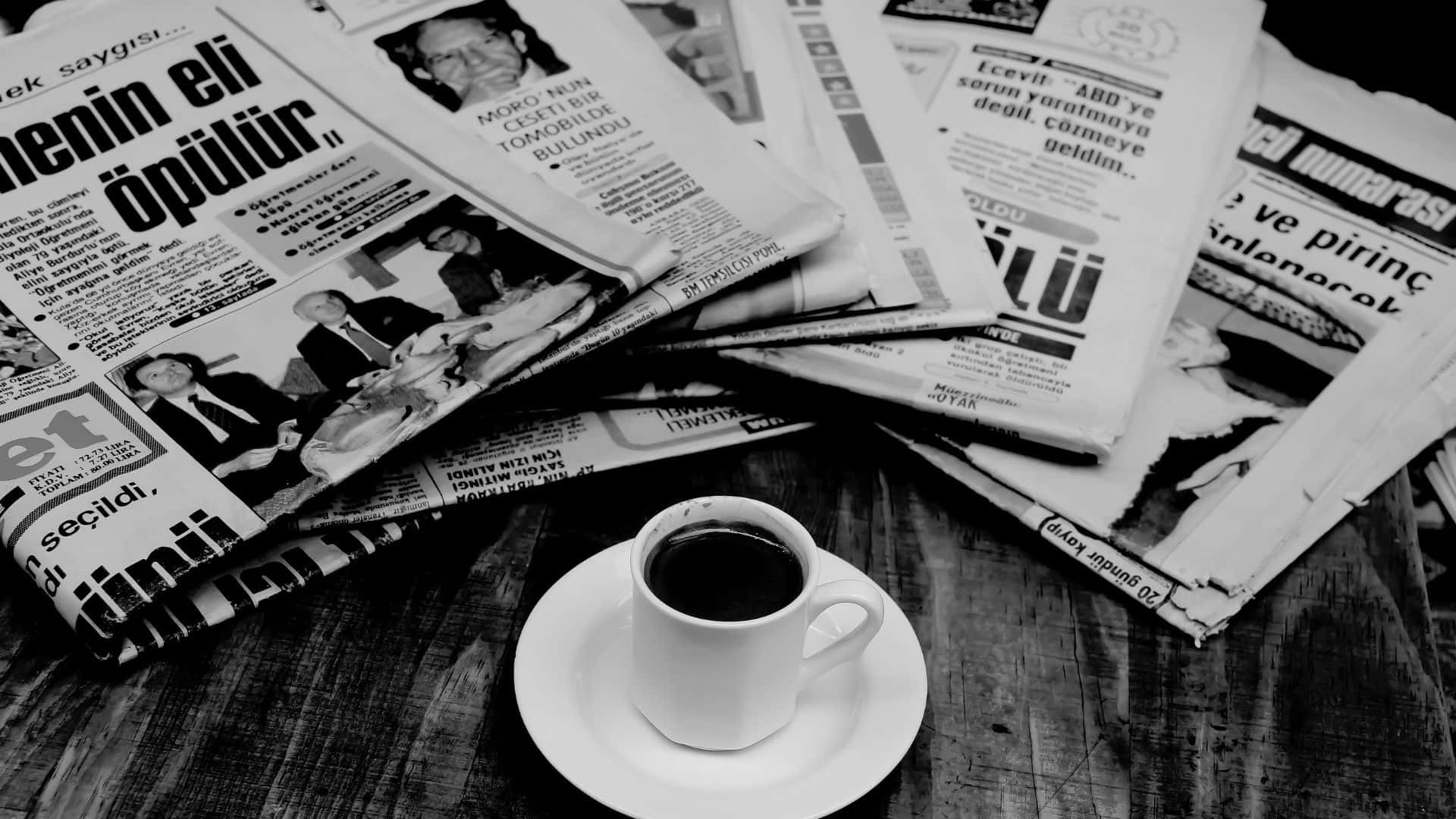 Black And White Newspaper 桌布 壁紙 — 一杯黑白咖啡放在碟子上，置於一張被散落的土耳其報紙包圍的木桌上。