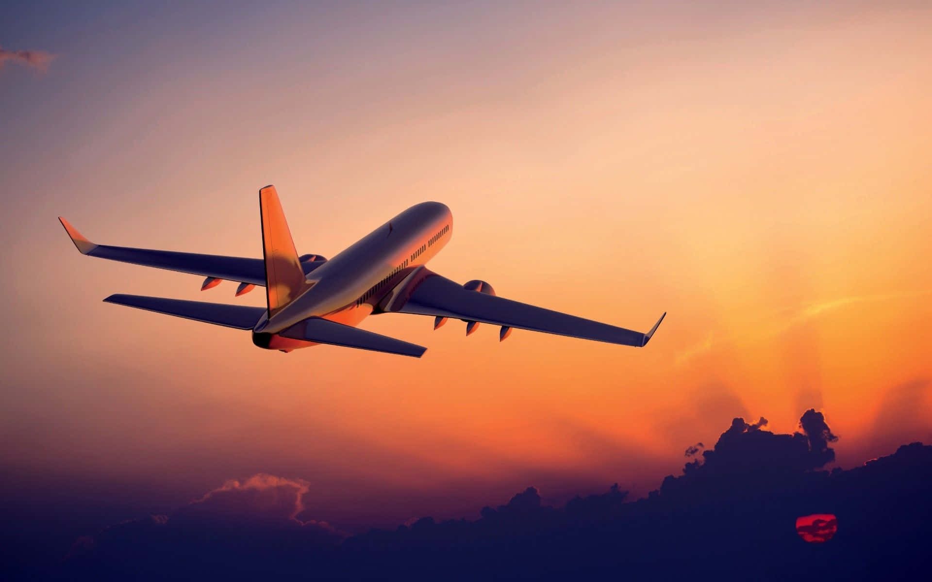 3d Travel 桌布 壁紙 — 一架商用飛機在充滿活力的日落天空中翱翔，橙色和紫色的色調映襯著輪廓分明的雲層。