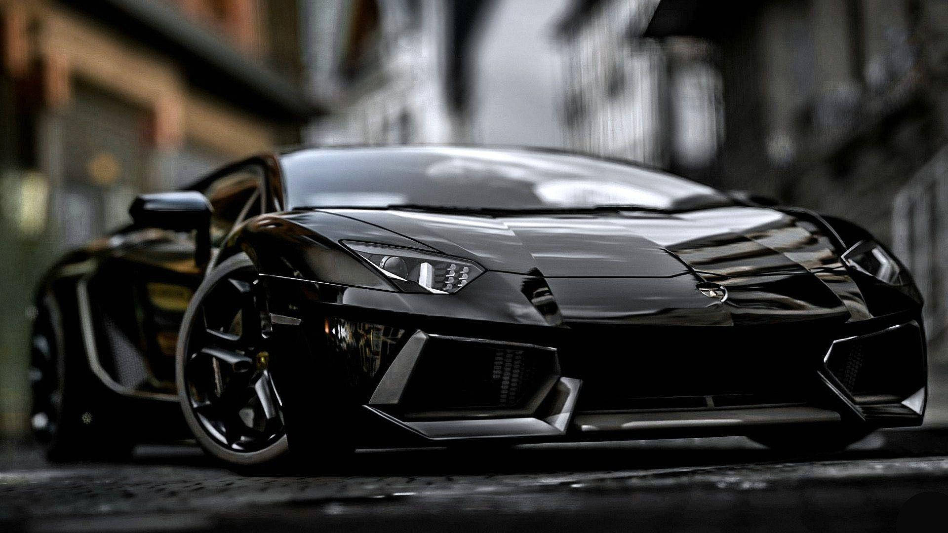 New 桌布 壁紙 — 一架型格黑色林寶堅尼 Aventador 停泊在濕漉漉的都市街道上，背景是模糊的建築物。
