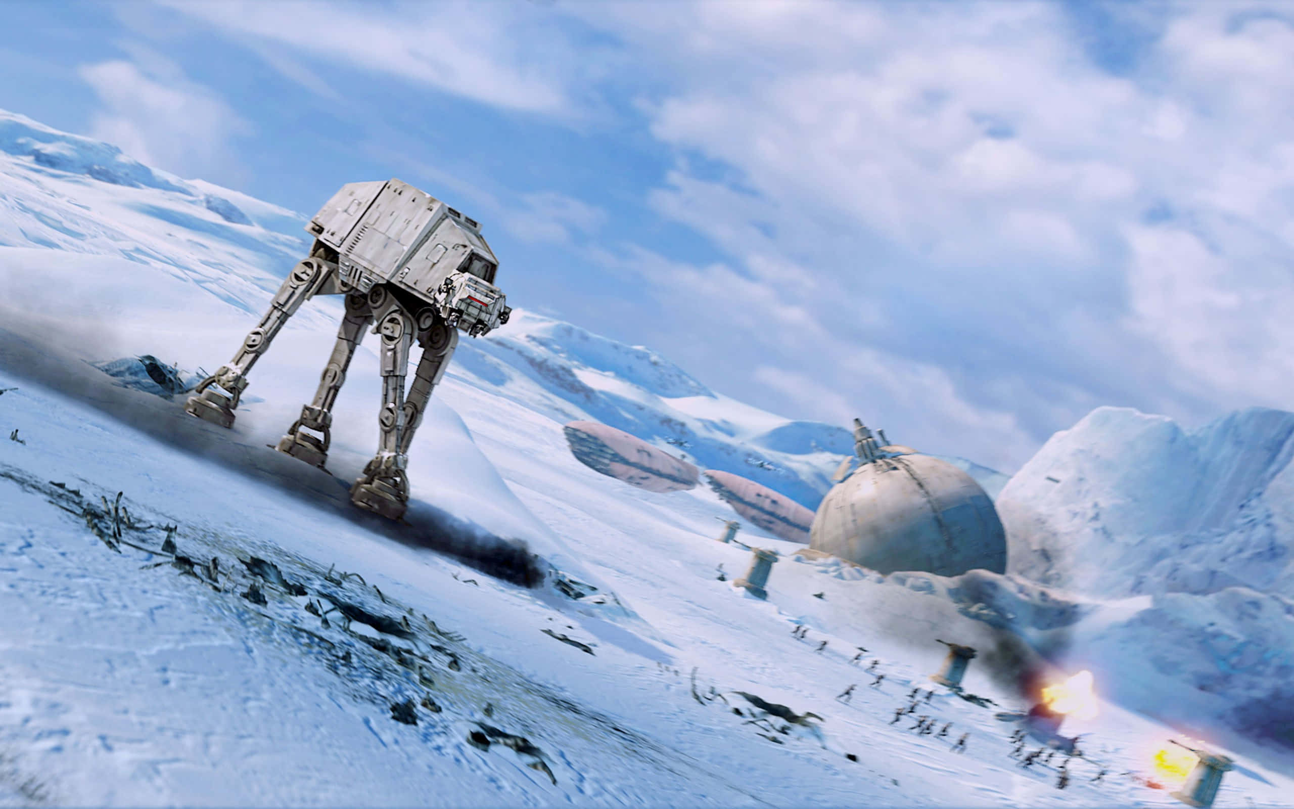 At-at 桌布 壁紙 — 一架巨大的AT-AT步行機在白雪皚皚的戰場上行進，伴隨著爆炸和遠處的建築物，天空湛藍。