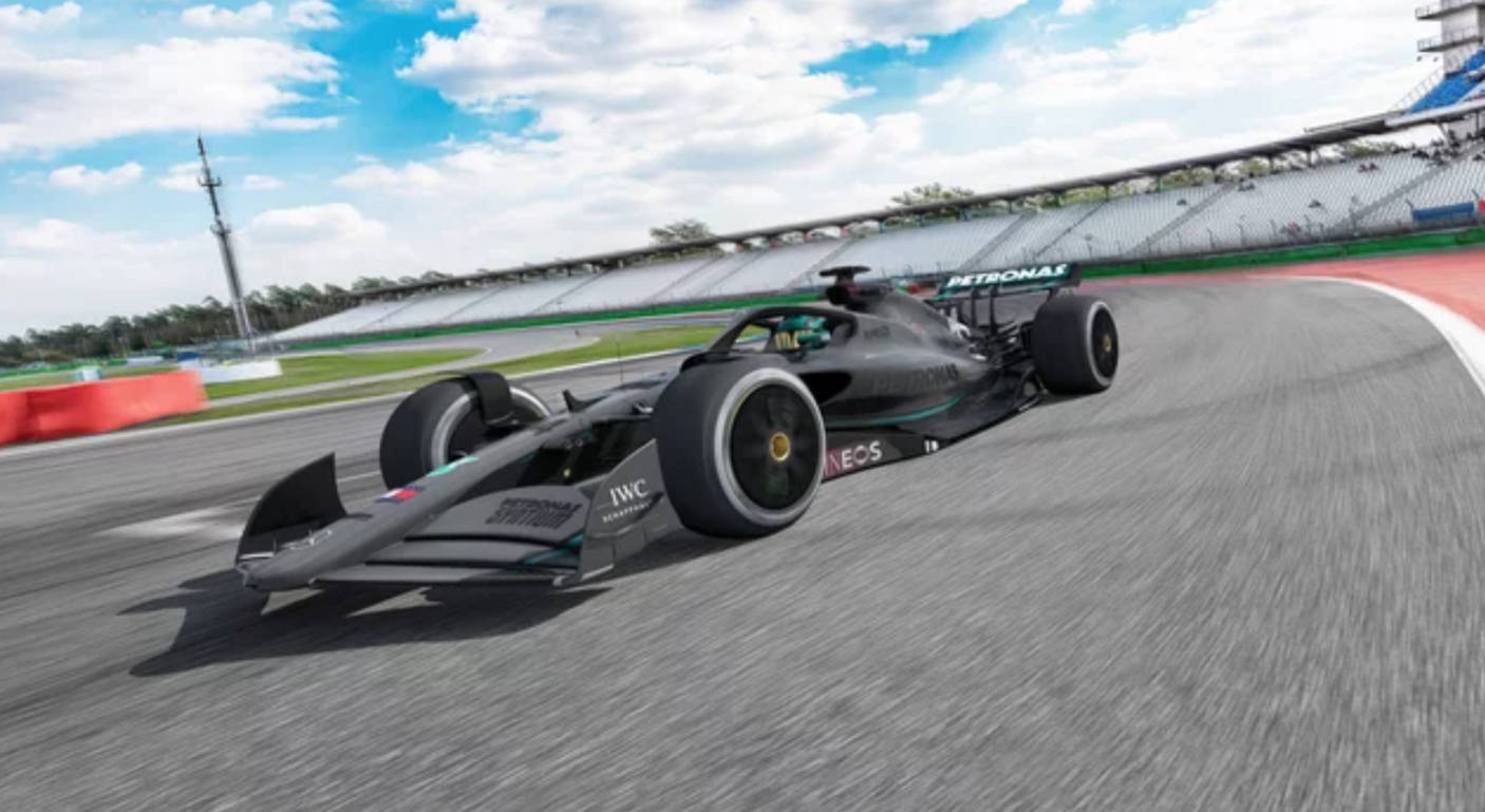 AMG F1 4K 壁紙 — 一架帶有Petronas標誌的時尚黑色一級方程式賽車，在藍天白雲下沿著彎曲的瀝青賽道奔馳。