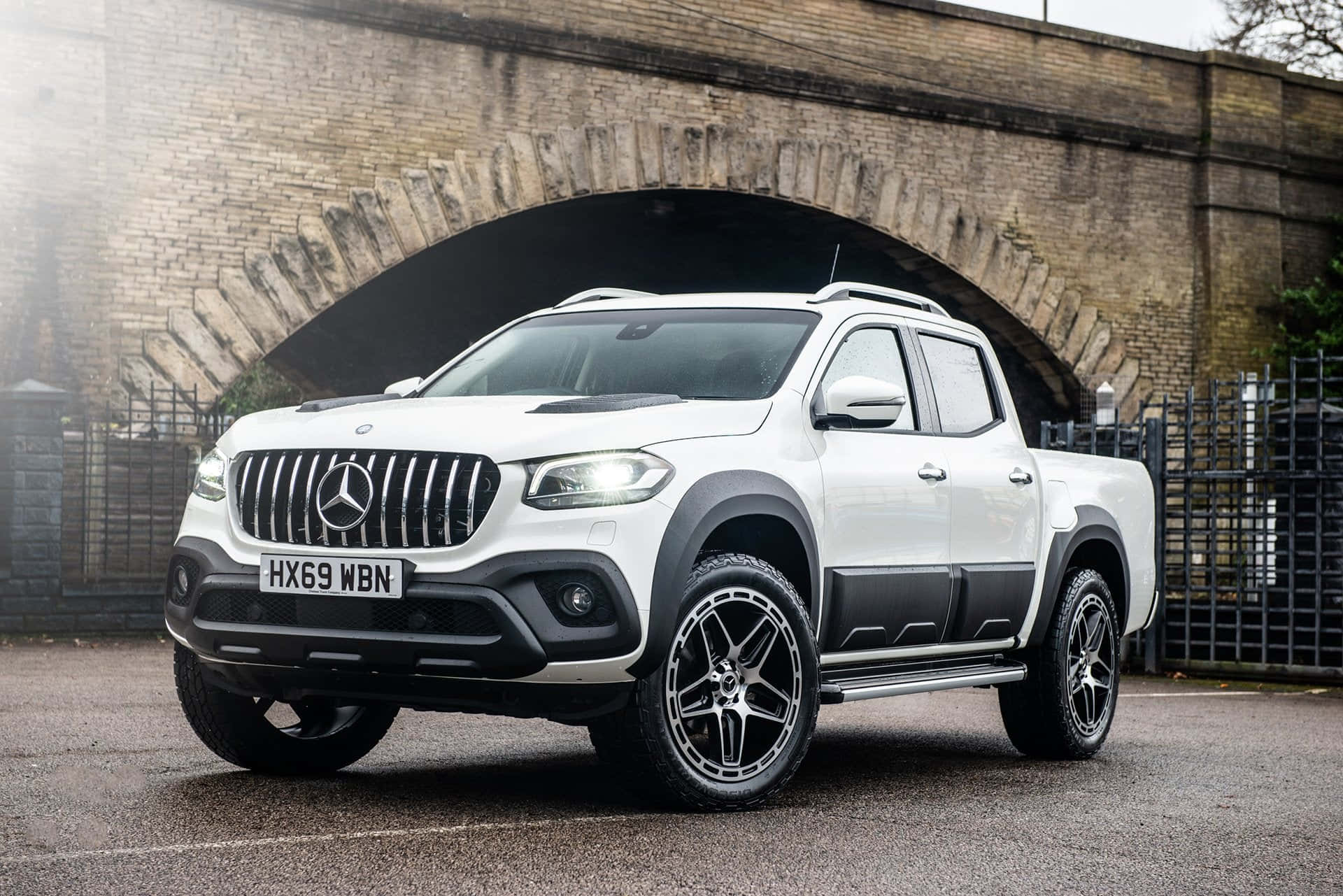 Mercedes Benz X-class 桌布 壁紙 — 一架時尚的白色 Mercedes-Benz 貨卡停泊在風化的磚拱門下，氣氛迷霧籠罩。
