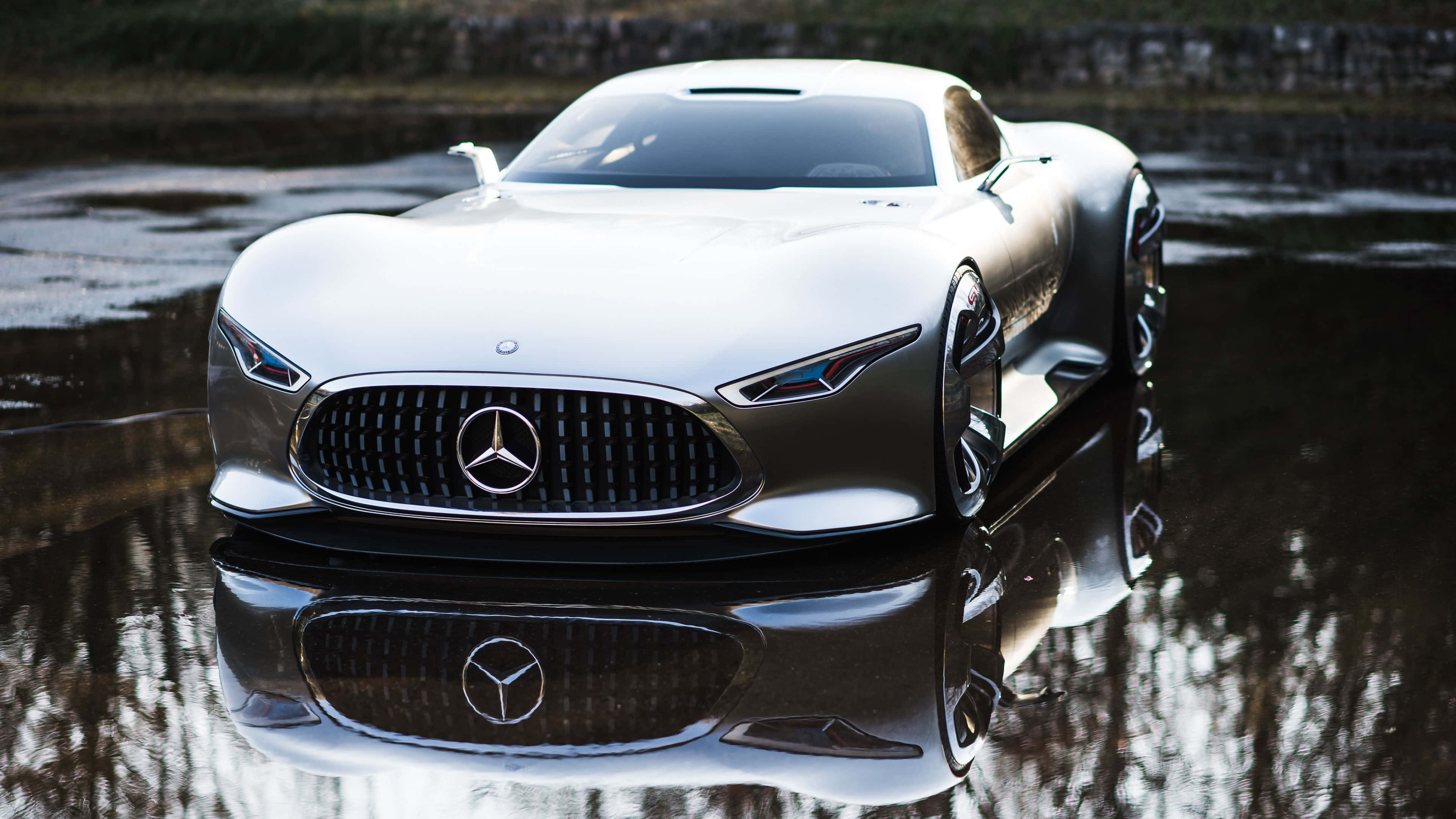4K Mercedes 桌布 壁紙 — 一架流線型銀色 Mercedes 概念車在柔和日光下完美倒映在淺水窪中。