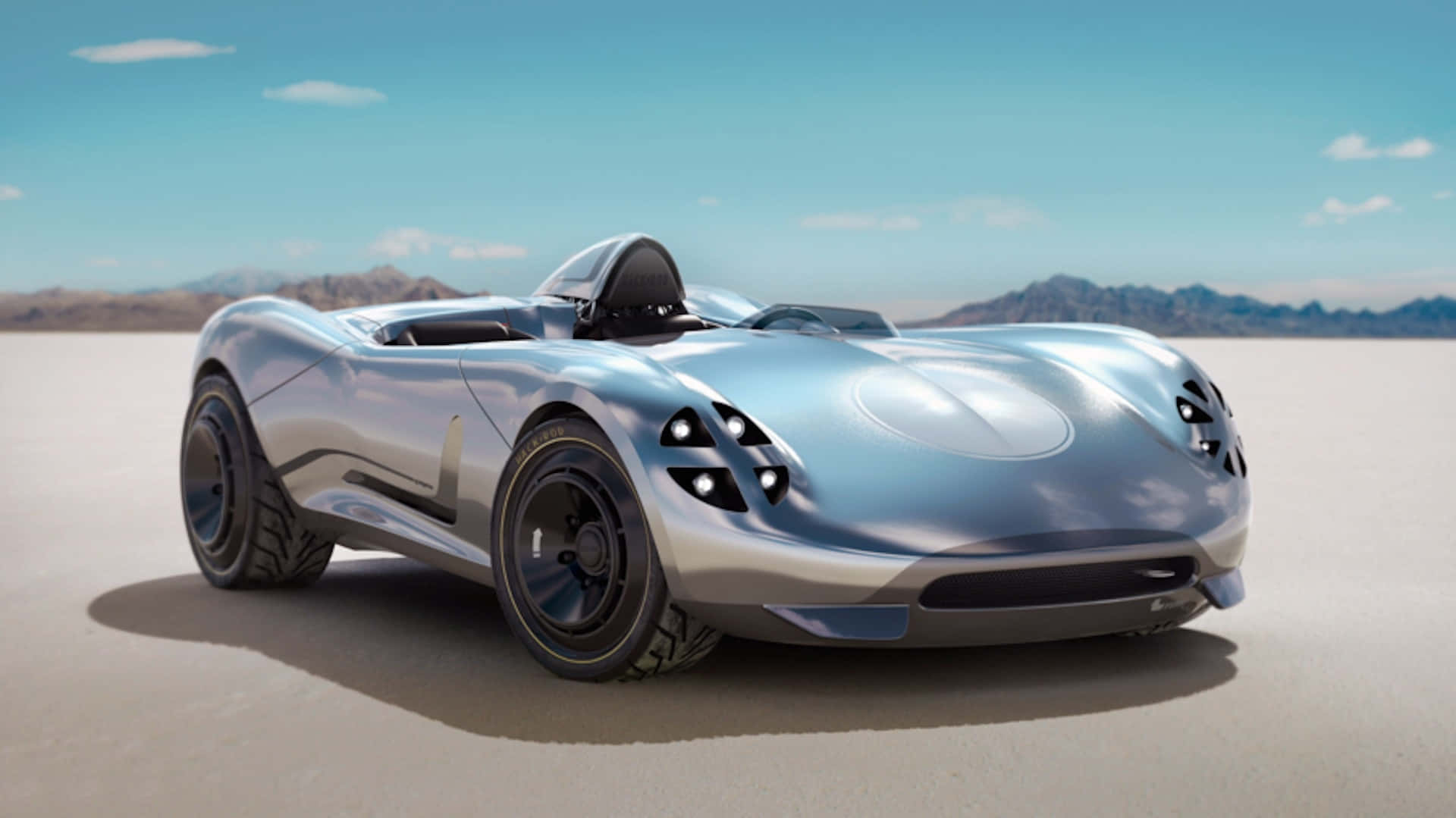 Car Design 桌布 壁紙 — 一架流線型銀色未來感跑車，帶有黑色點綴，停泊在廣闊的沙漠平原上，背景是晴朗的藍天和遠山。