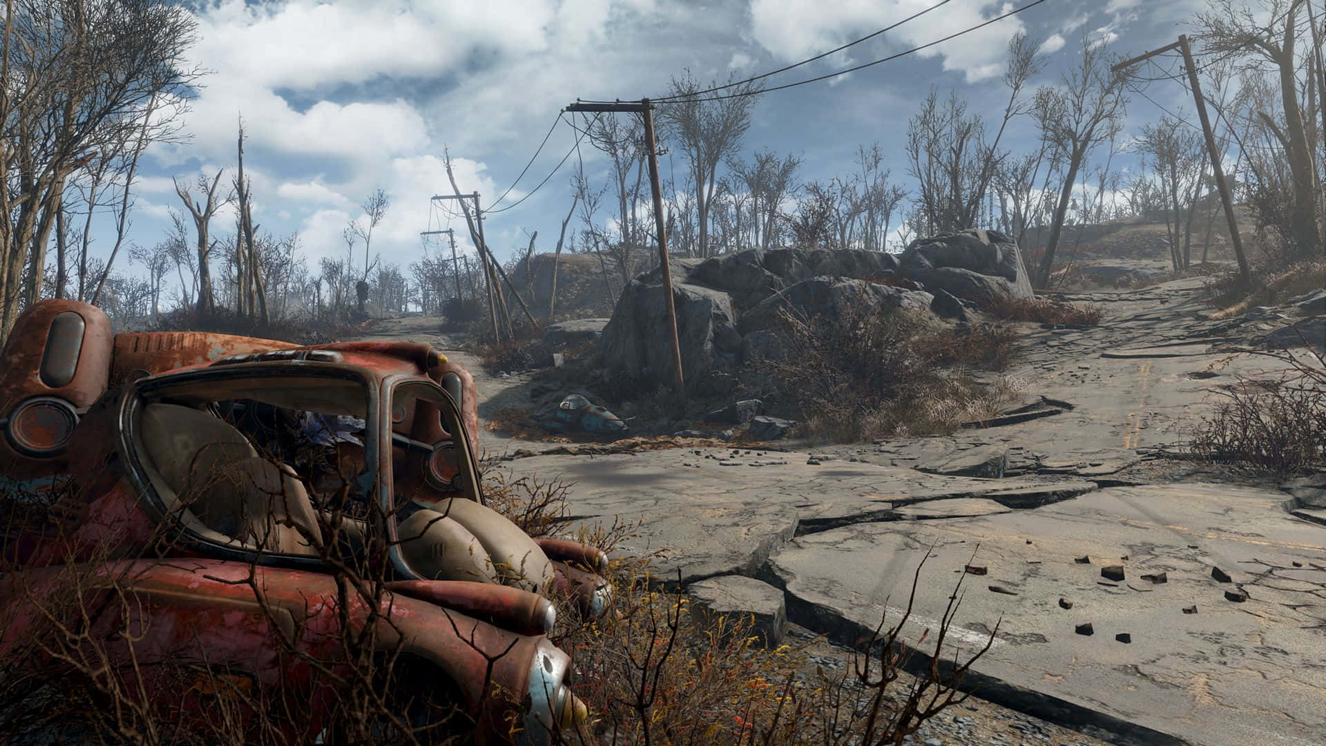Fallout 4 Wasteland 桌布 壁紙 — 一架生鏽的紅色汽車被遺棄在一條龜裂的道路上，周圍是荒涼的末日後廢土，有光禿禿的樹木和斷裂的電線。