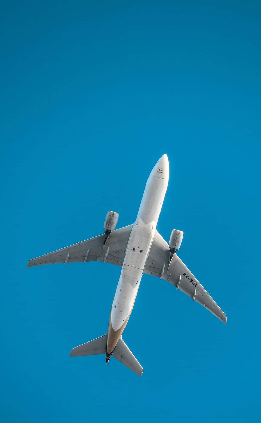 4K 飛機壁紙 桌布 壁紙 — 一架白色商用飛機在清澈湛藍的天空中翱翔。