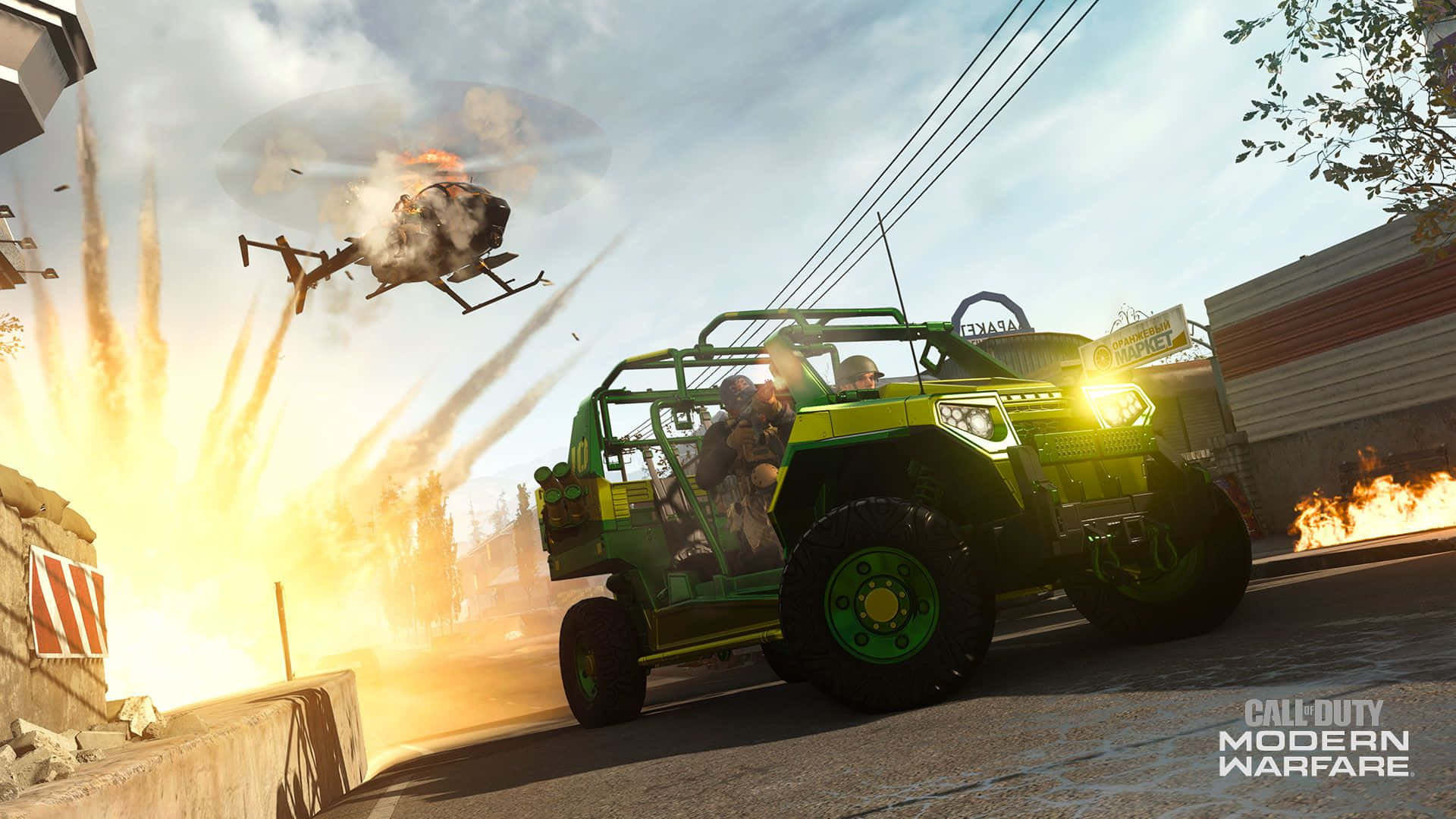 Call Of Duty Vehicles 桌布 壁紙 — 一架綠色裝甲車在城市街道上疾馳，身後一架燃燒的直升機正在爆炸。