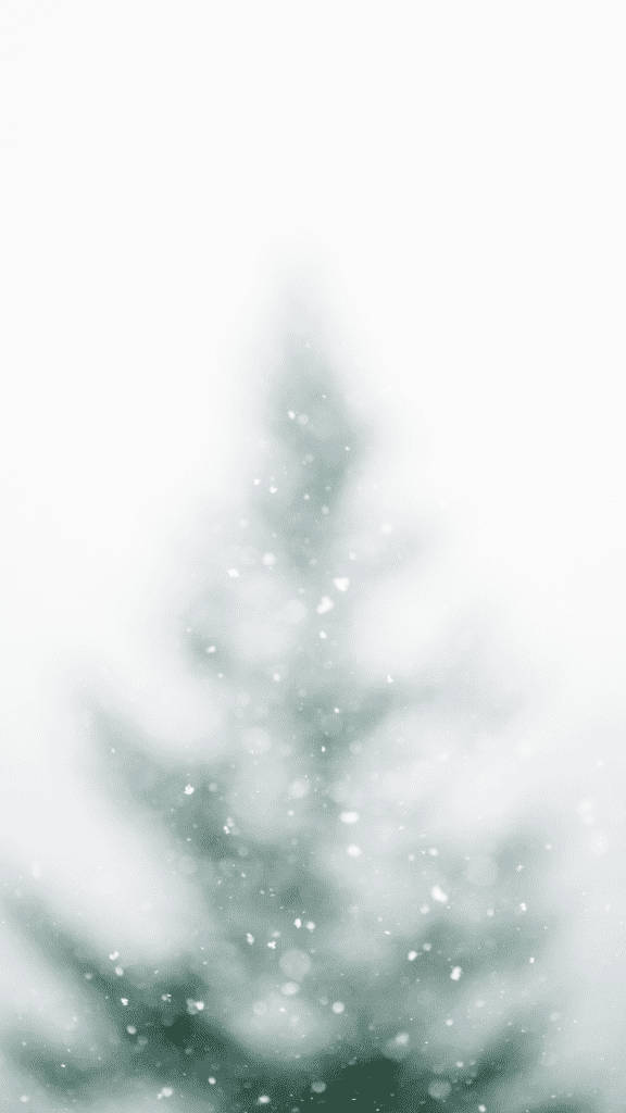 聖誕樹 桌布 壁紙 — 一棵柔和模糊的常青樹矗立在雪白的冬日場景中，伴隨著輕柔飄落的雪花，背景是明亮的白色。