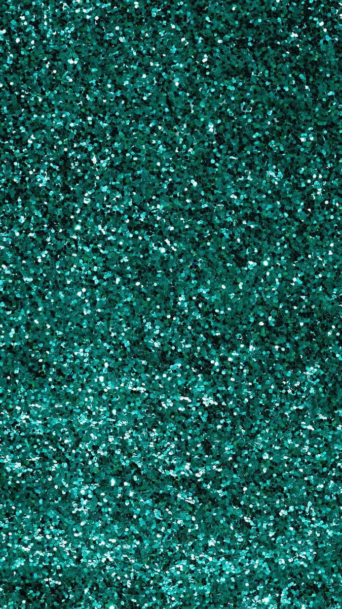Turquoise Green 桌布 壁紙 — 一片密集閃爍的藍綠色閃粉，營造出帶有明亮反光高光的閃爍紋理表面。