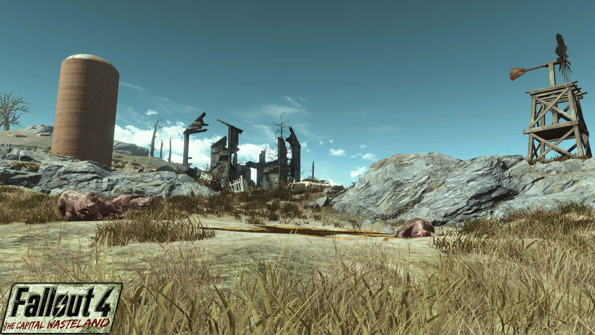 Fallout 4 The Capital Wasteland 桌布 壁紙 — 一片荒涼的末世廢土，有搖搖欲墜的建築物、生鏽的筒倉和風車，在清澈的藍天下。