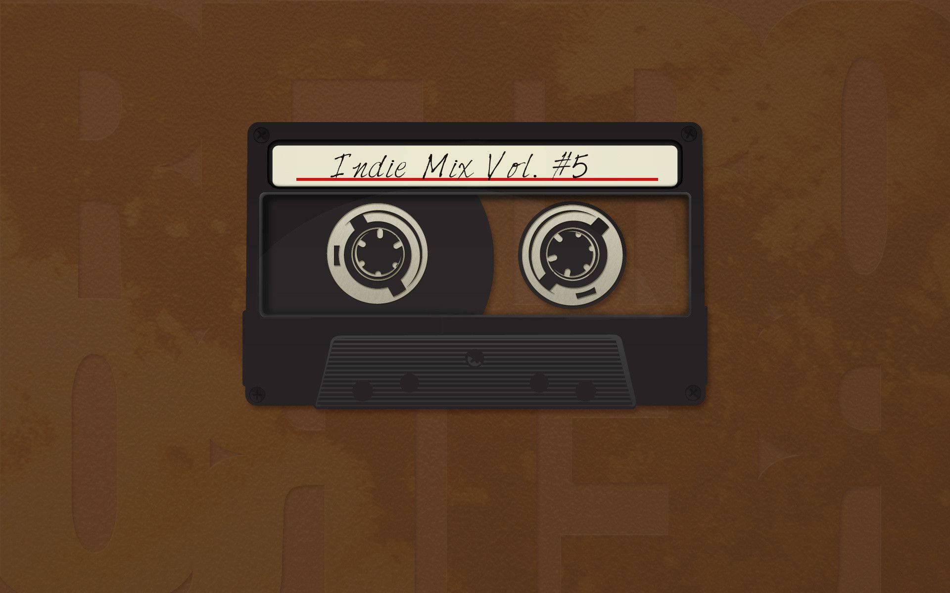Laptop 桌布 壁紙 — 一盒標有「Indie Mix Vol. #5」的復古黑色卡式錄音帶，放置在帶有紋理的棕色背景上。
