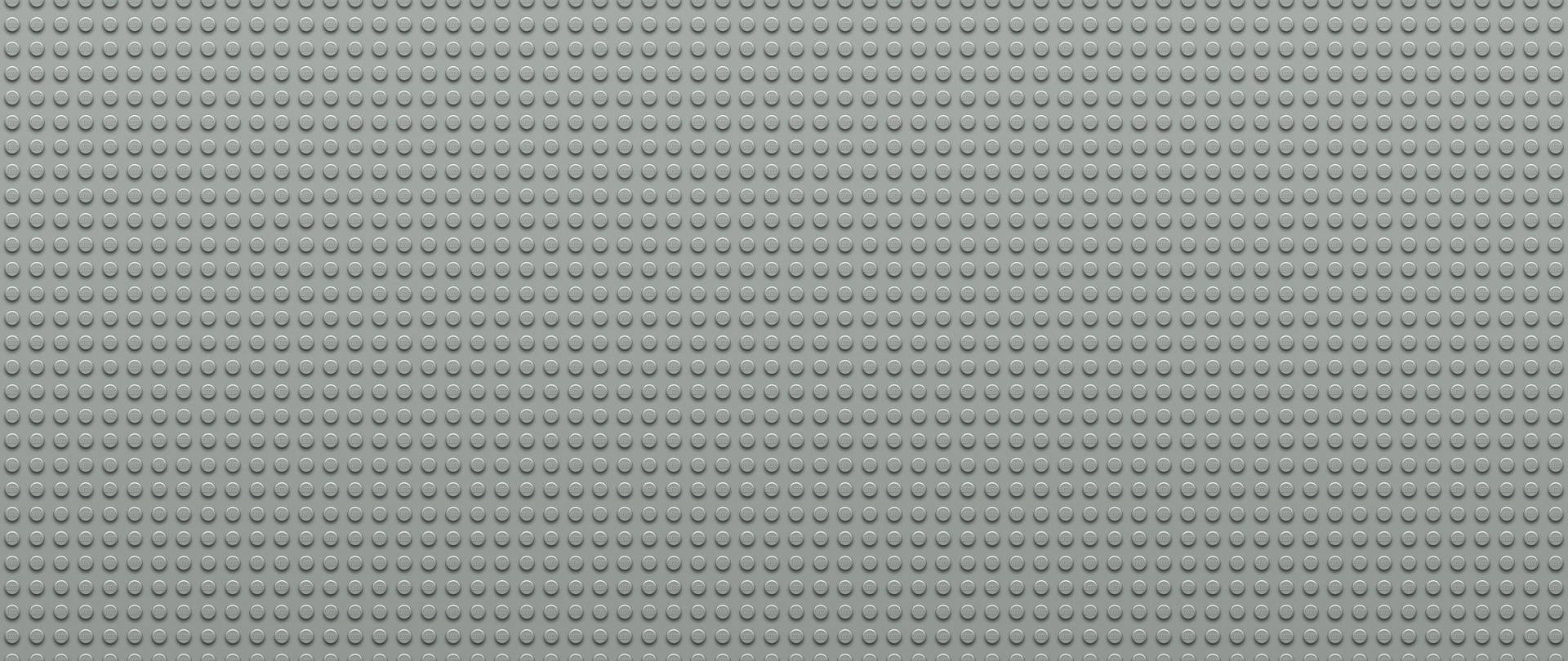 灰色LEGO底板，帶有重複的圓形凸點用於搭建。