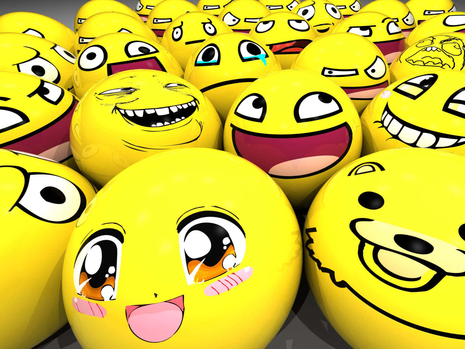Smiley 桌布 壁紙 — 一組密集的光澤黃色表情符號球體，展示從喜悅到憤怒的各種卡通表情。