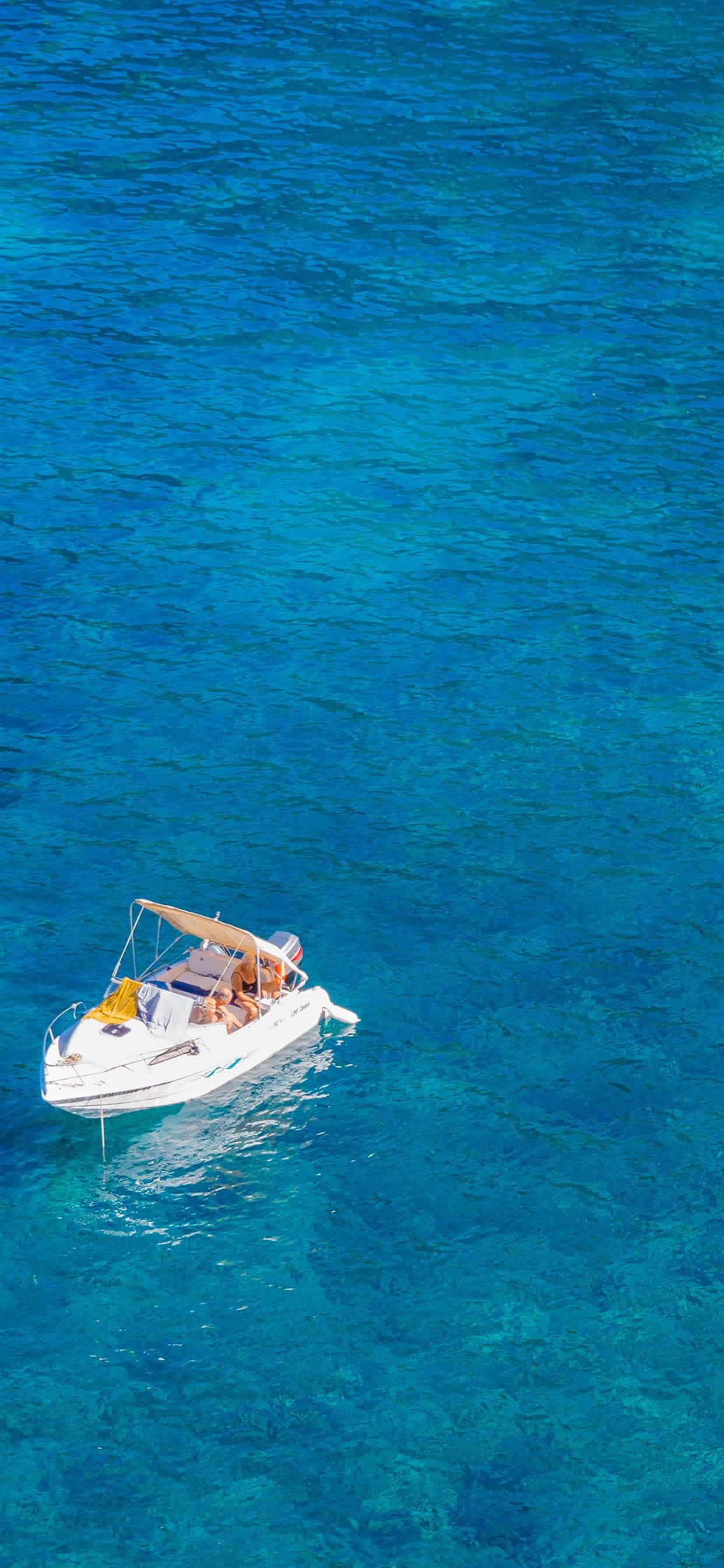 Boating 桌布 壁紙 — 一艘白色機動船載著乘客在明亮的日光下滑過充滿活力的碧綠海水。