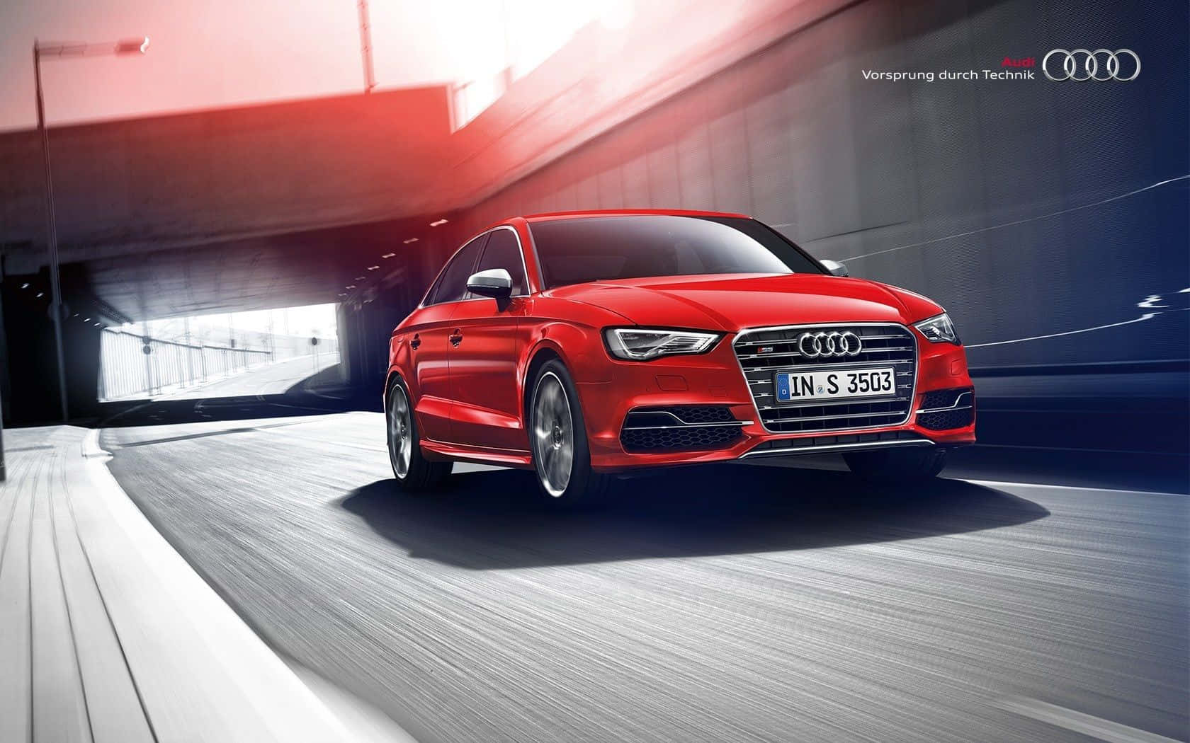 Audi S3 桌布 壁紙 — 一輛充滿活力的紅色奧迪S3轎車在現代隧道中疾馳，動態模糊效果凸顯其卓越性能。