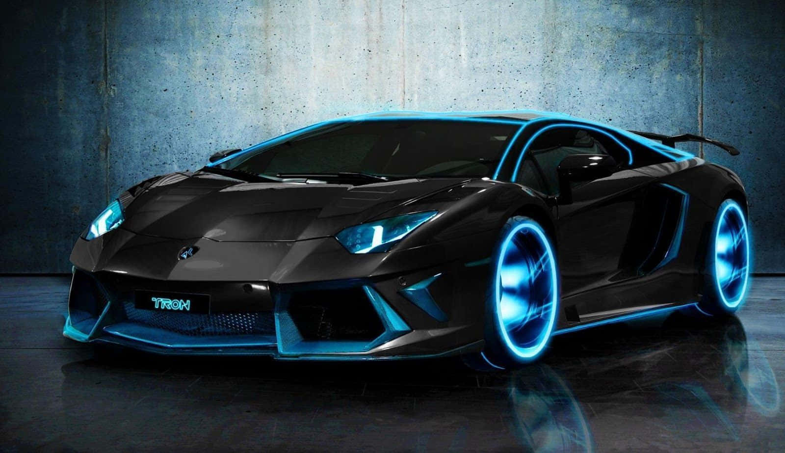 Sports Car 桌布 壁紙 — 一輛光滑的黑色林寶堅尼 Aventador，帶有發光藍色霓虹燈飾和 'TRON' 車牌，停在昏暗的混凝土車庫中。