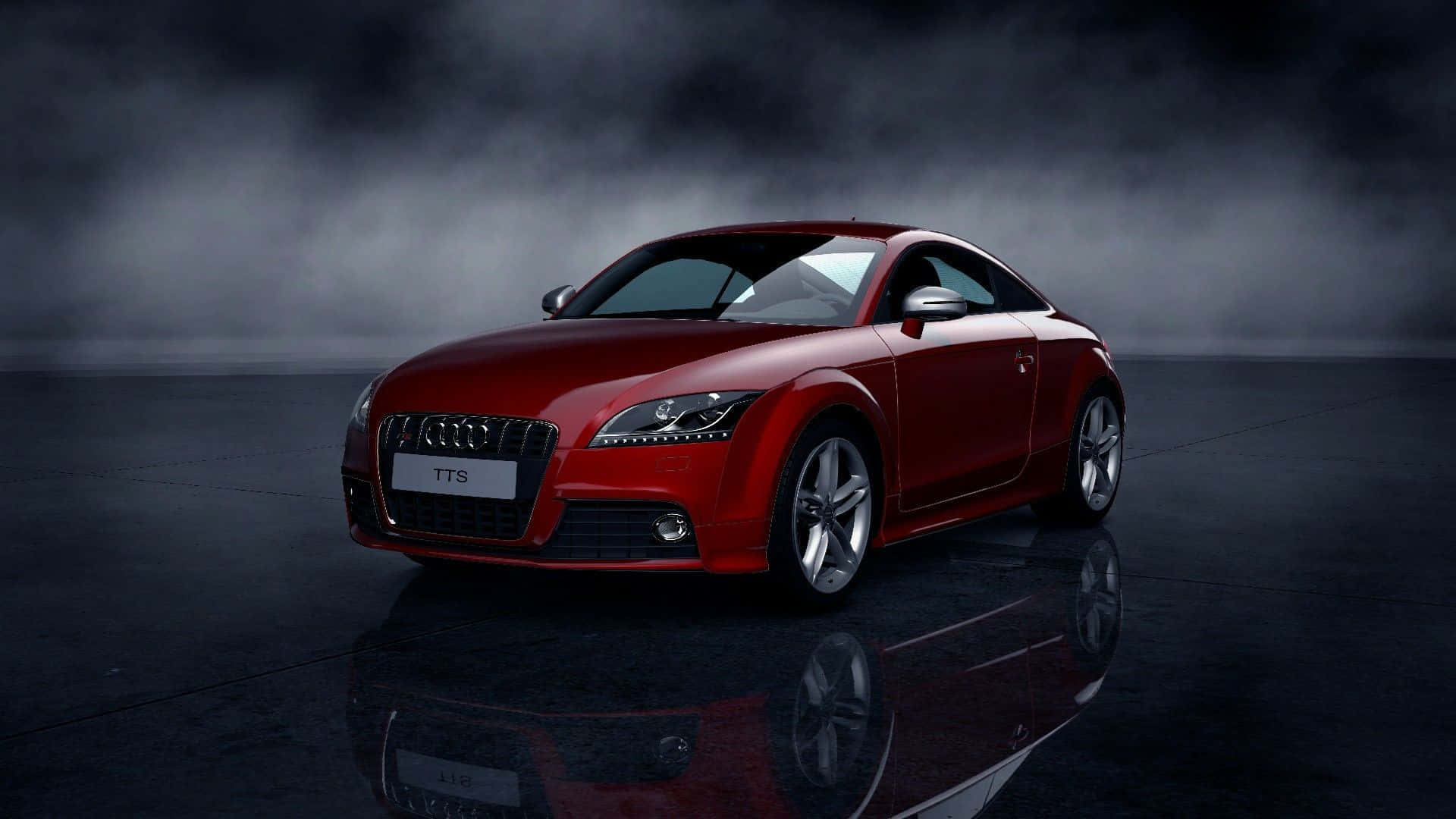 Audi Tt 桌布 壁紙 — 一輛光澤的紅色 Audi TTS 跑車在戲劇性的攝影棚燈光下，於煙霧瀰漫的深色背景和反光地板上閃耀。