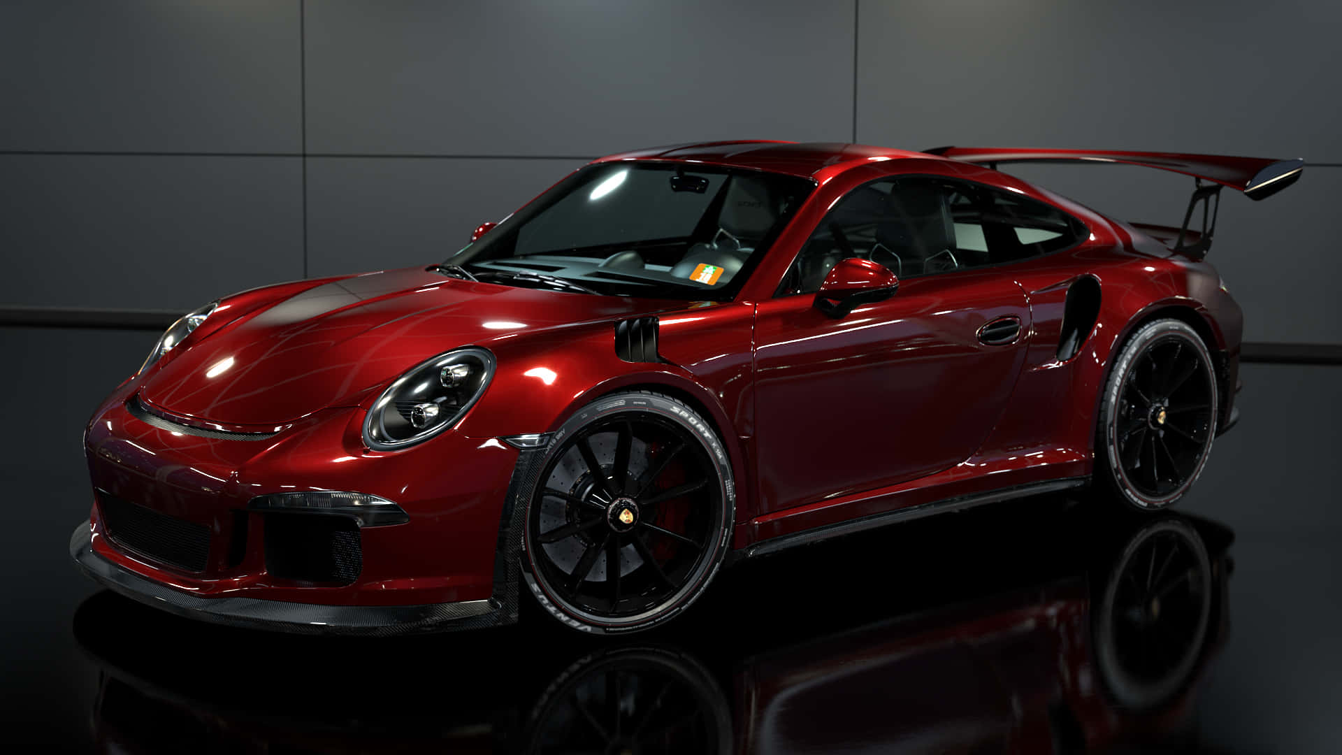 保時捷 桌布 壁紙 — 一輛光澤的紅色保時捷911 GT2 RS，配備黑色輪圈和後擾流板，在反射地板上的工作室燈光下閃耀。
