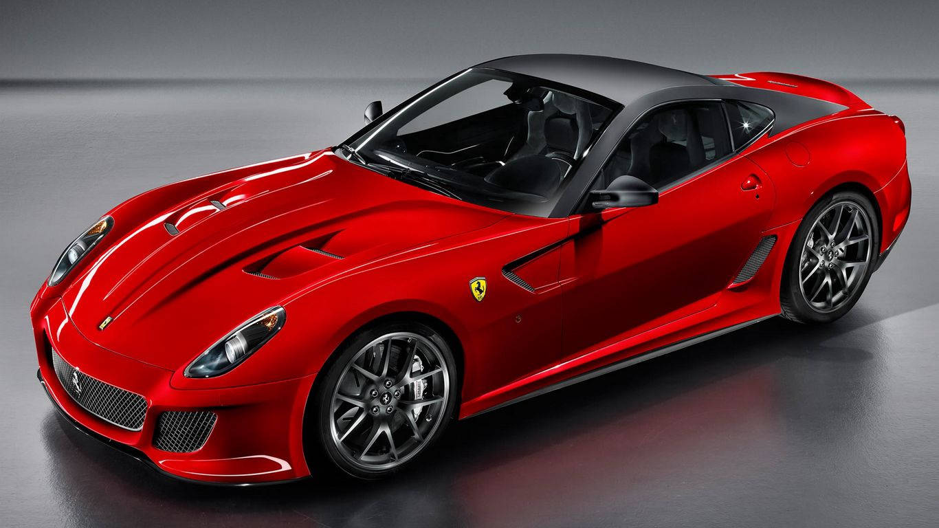 Sports Car 桌布 壁紙 — 一輛光澤的紅色法拉利跑車，帶有黑色飾邊和銀色輪圈，在極簡主義的攝影棚環境中展示。