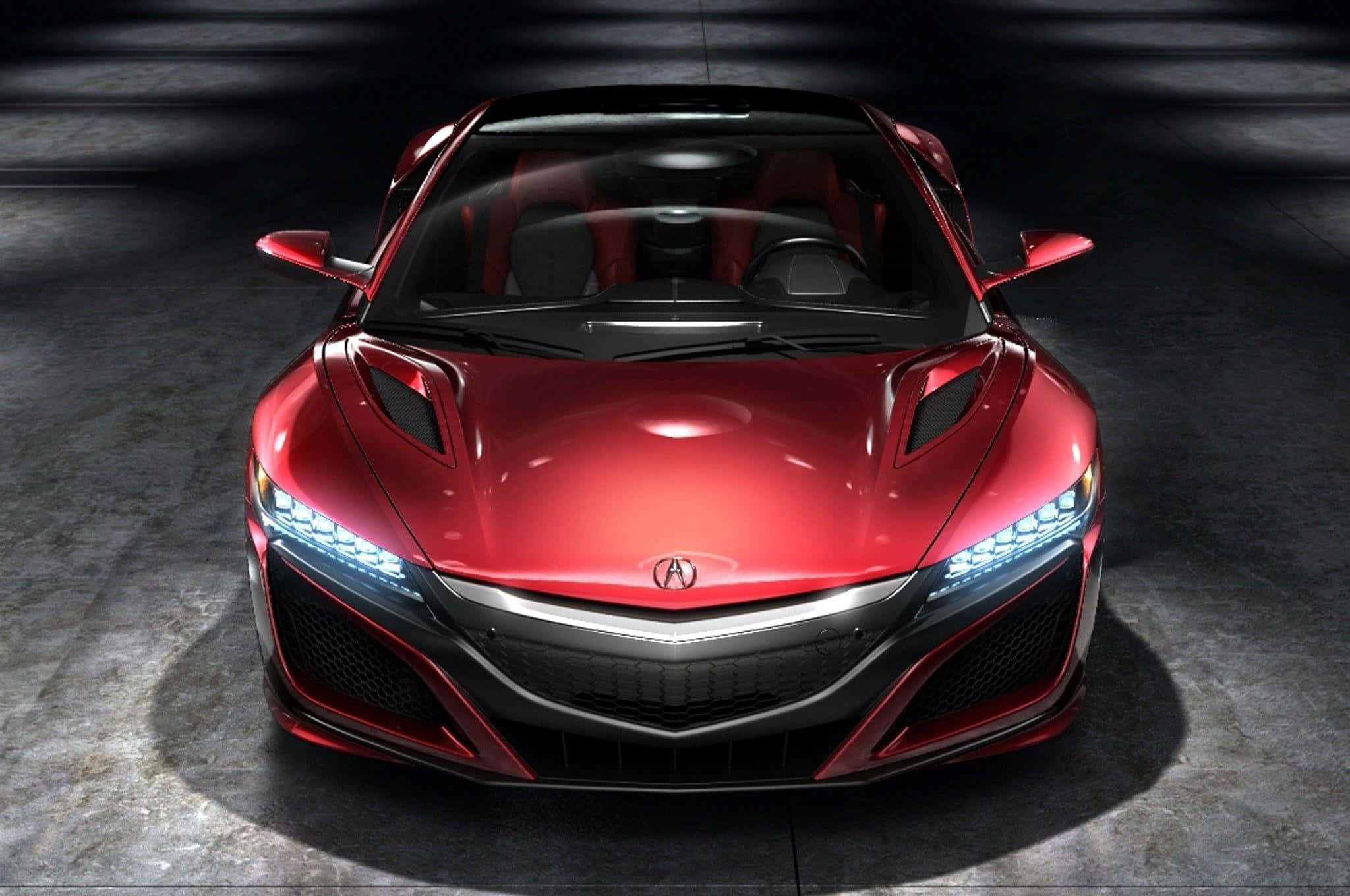 Acura Nsx 桌布 壁紙 — 一輛光澤的紅色跑車在昏暗的車庫中，在戲劇性的聚光燈下居中，車頭燈閃爍。