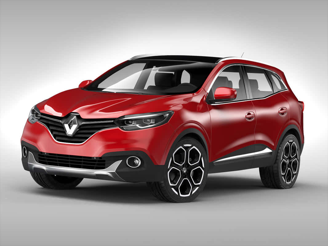 Car Model 桌布 壁紙 — 一輛光澤紅色雷諾SUV，帶有黑色飾邊和六角形輪圈，在灰色中性攝影棚背景下蓄勢待發。