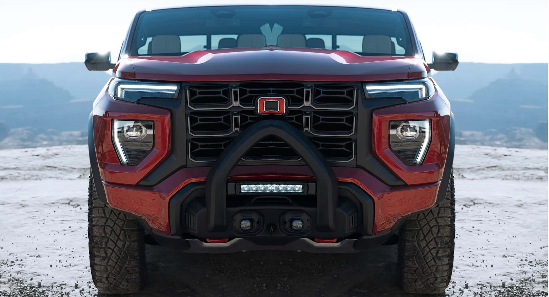 Gmc Canyon 桌布 壁紙 — 一輛大膽的紅色越野卡車，配備黑色格柵和LED燈，在白雪覆蓋的沙漠景觀中準備就緒。