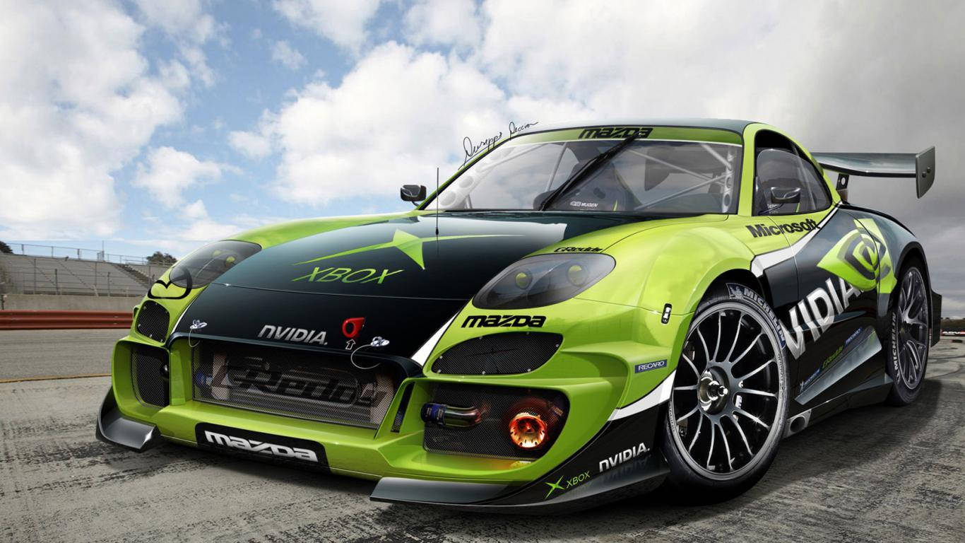 Mazda 桌布 壁紙 — 一輛帶有Nvidia和Xbox標誌的檸檬綠和黑色萬事得賽車，在多雲的天空下於賽道上飛馳。