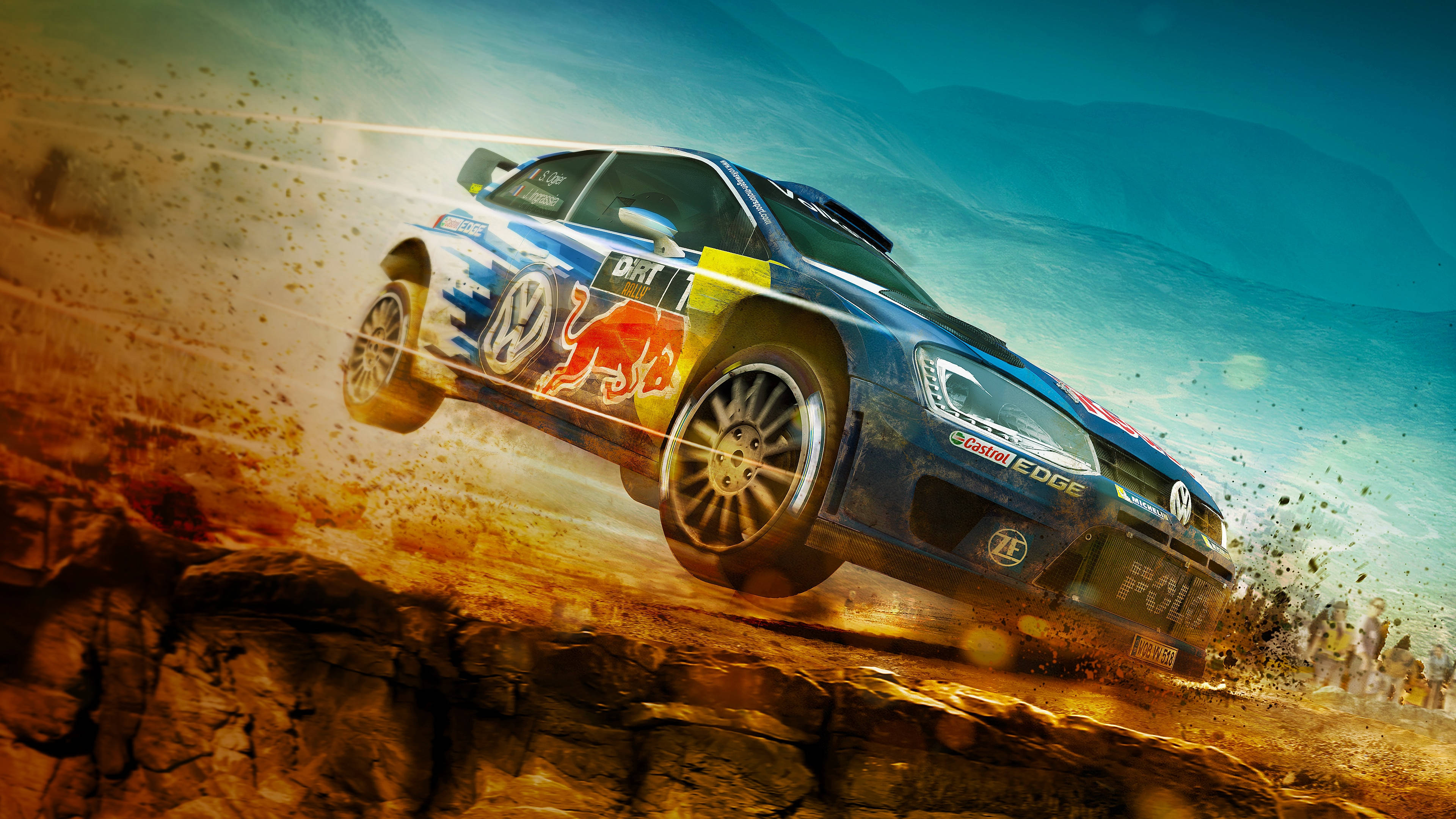 《Dirt Rally》Volkswagen Golf 壁紙 — 一輛帶有Red Bull塗裝的藍色拉力賽車在岩石地形上飛躍，揚起泥土和灰塵，背景是戲劇性的天空。