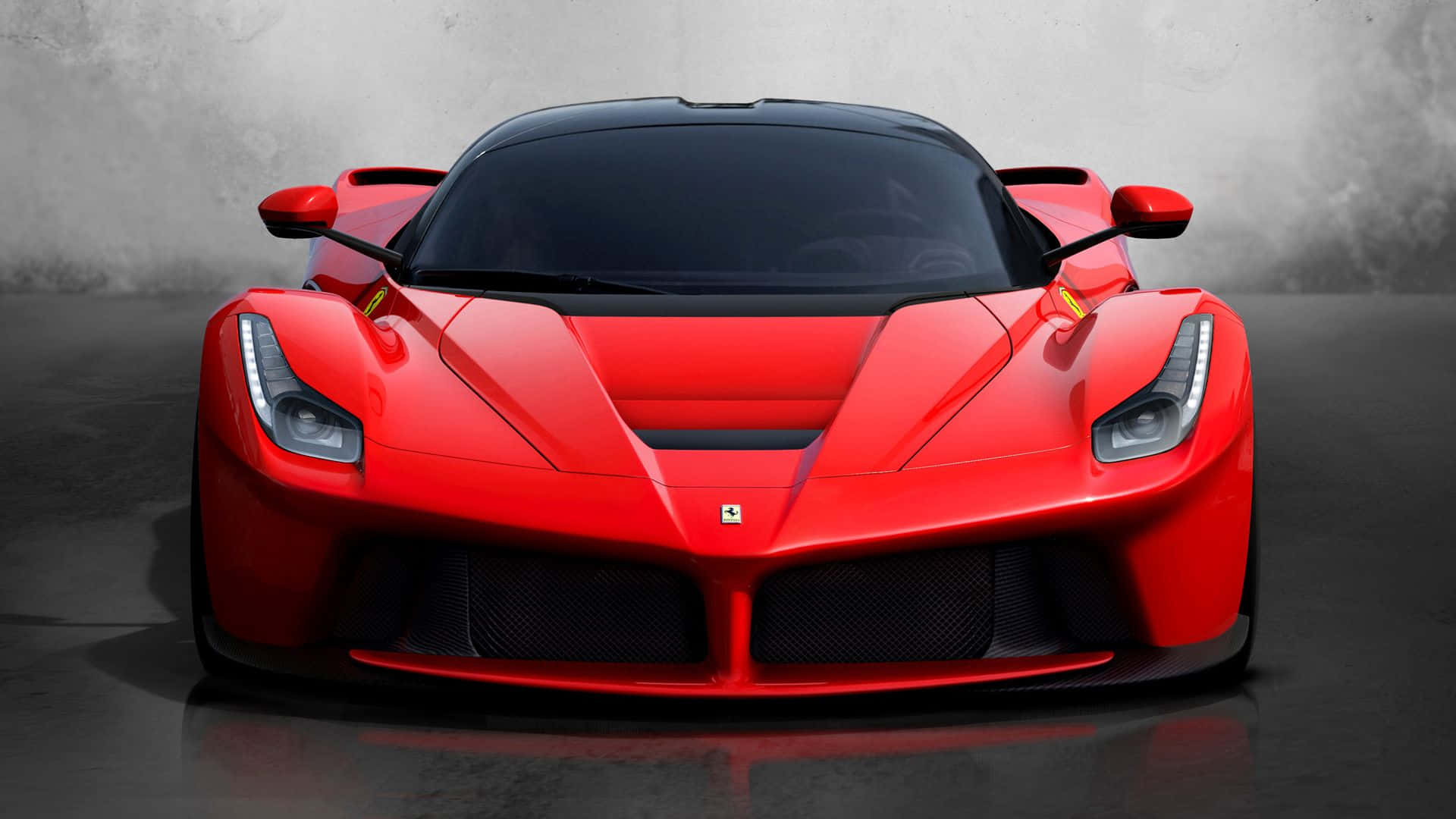 Ferrari Laferrari 桌布 壁紙 — 一輛引人注目的紅色法拉利LaFerrari在極簡風格的工作室中面向前方，地板具有反射效果，灰色混凝土牆壁。