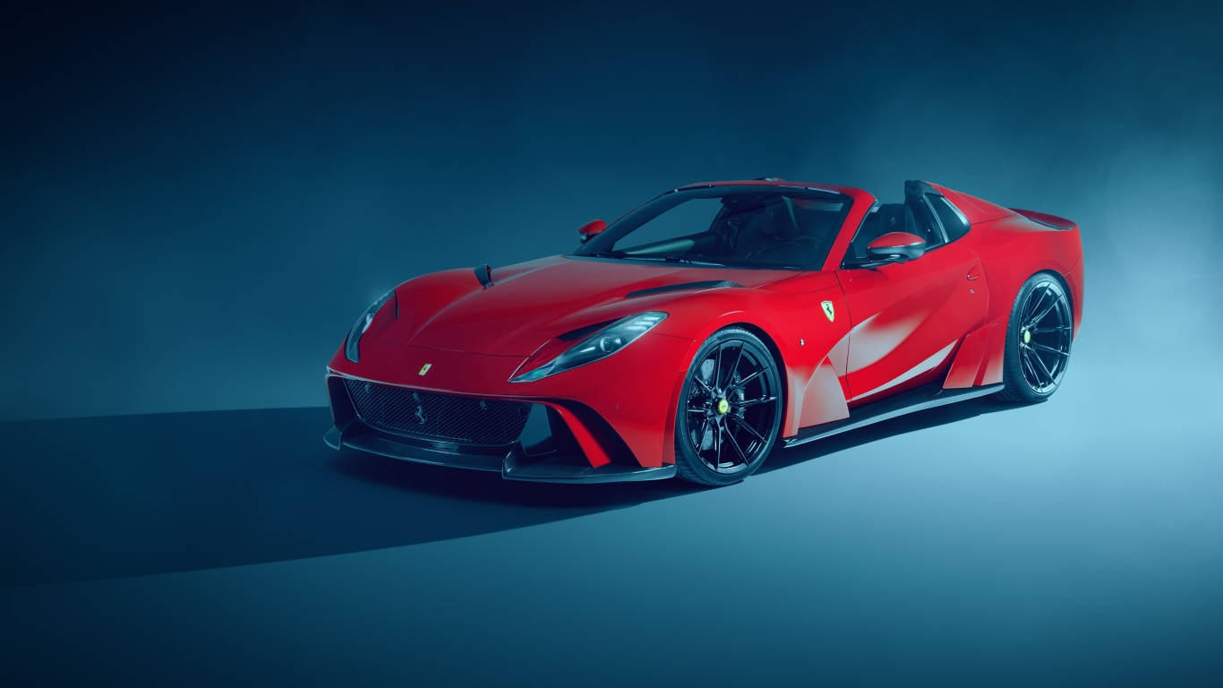 Sports Car 桌布 壁紙 — 一輛引人注目的紅色法拉利跑車，帶有黑色飾邊，在戲劇性的藍色工作室燈光下閃耀。