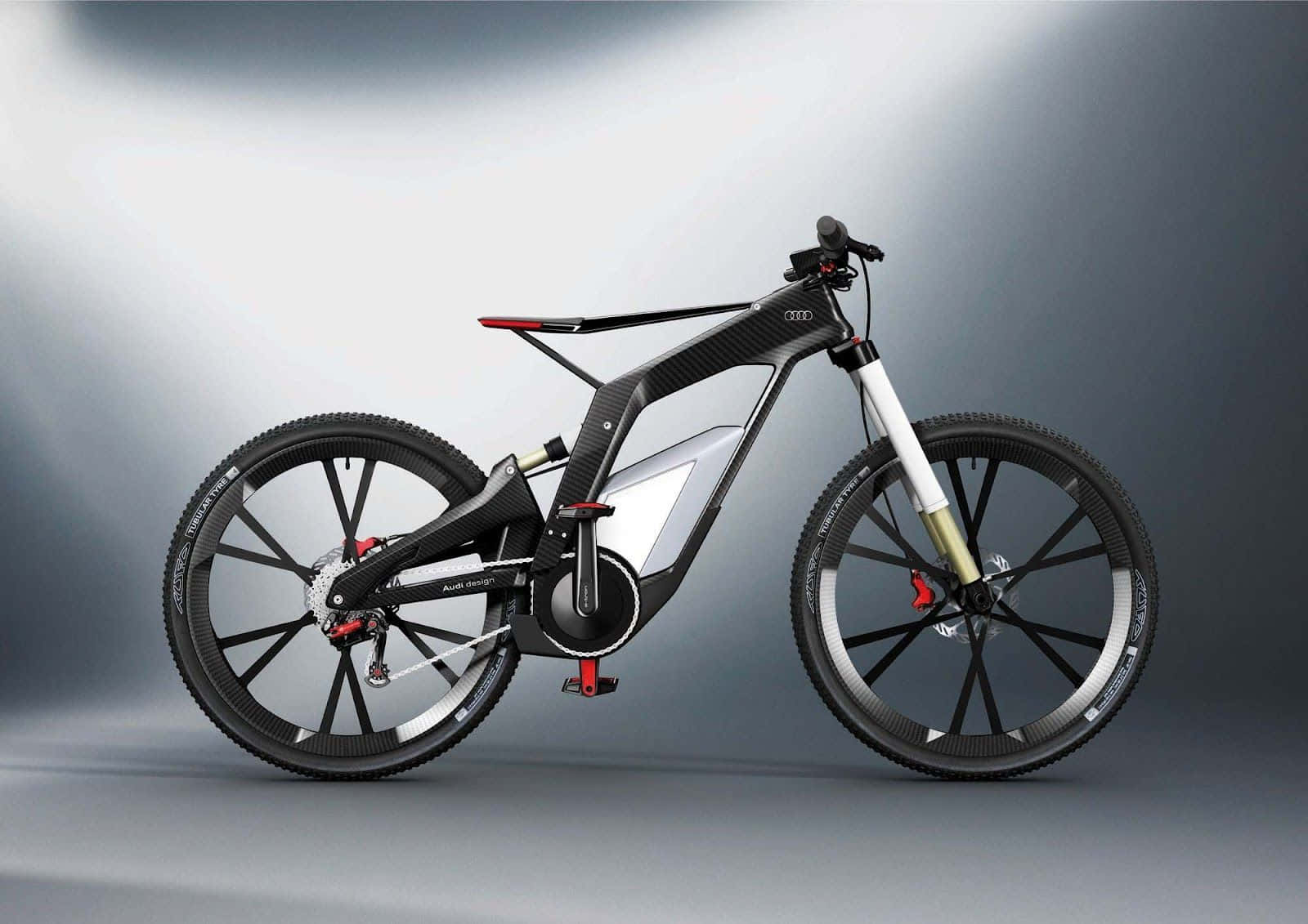 Electric Bike 桌布 壁紙 — 一輛時尚未來感十足的Audi電動山地單車，配備碳纖維車架和白色避震，矗立在漸變灰色工作室背景前。