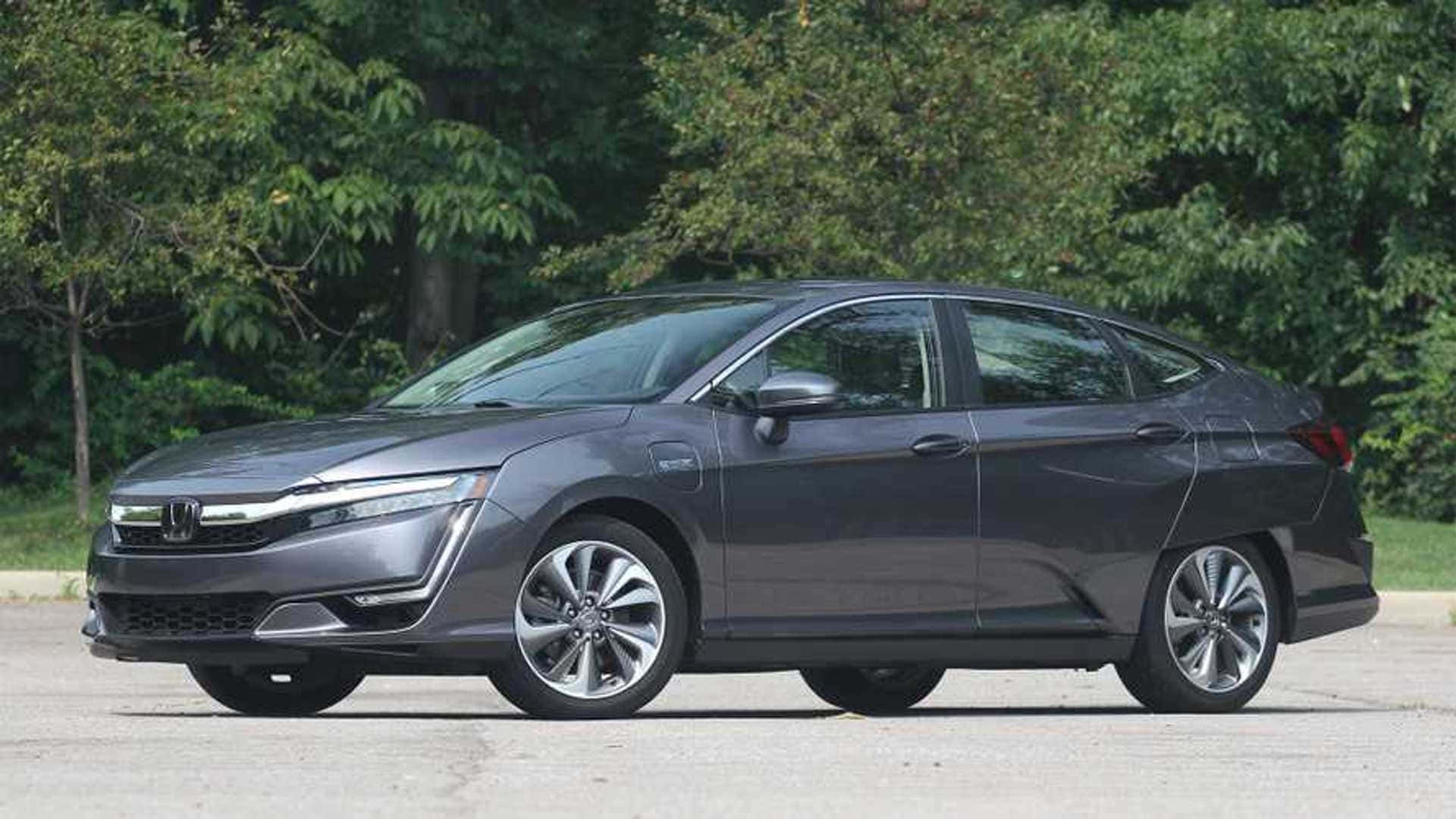 Honda Clarity 桌布 壁紙 — 一輛時尚的深灰色本田轎車停在路面上，背景是茂密的綠色樹木。