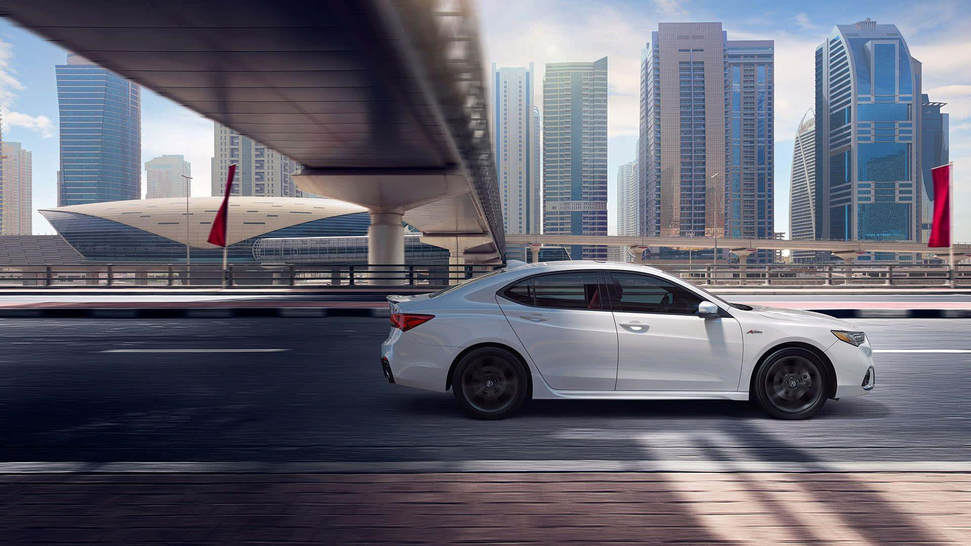 Acura Tlx 桌布 壁紙 — 一輛時尚的白色轎車在現代高架橋下行駛，背景是高聳的玻璃摩天大樓和明亮的藍天。