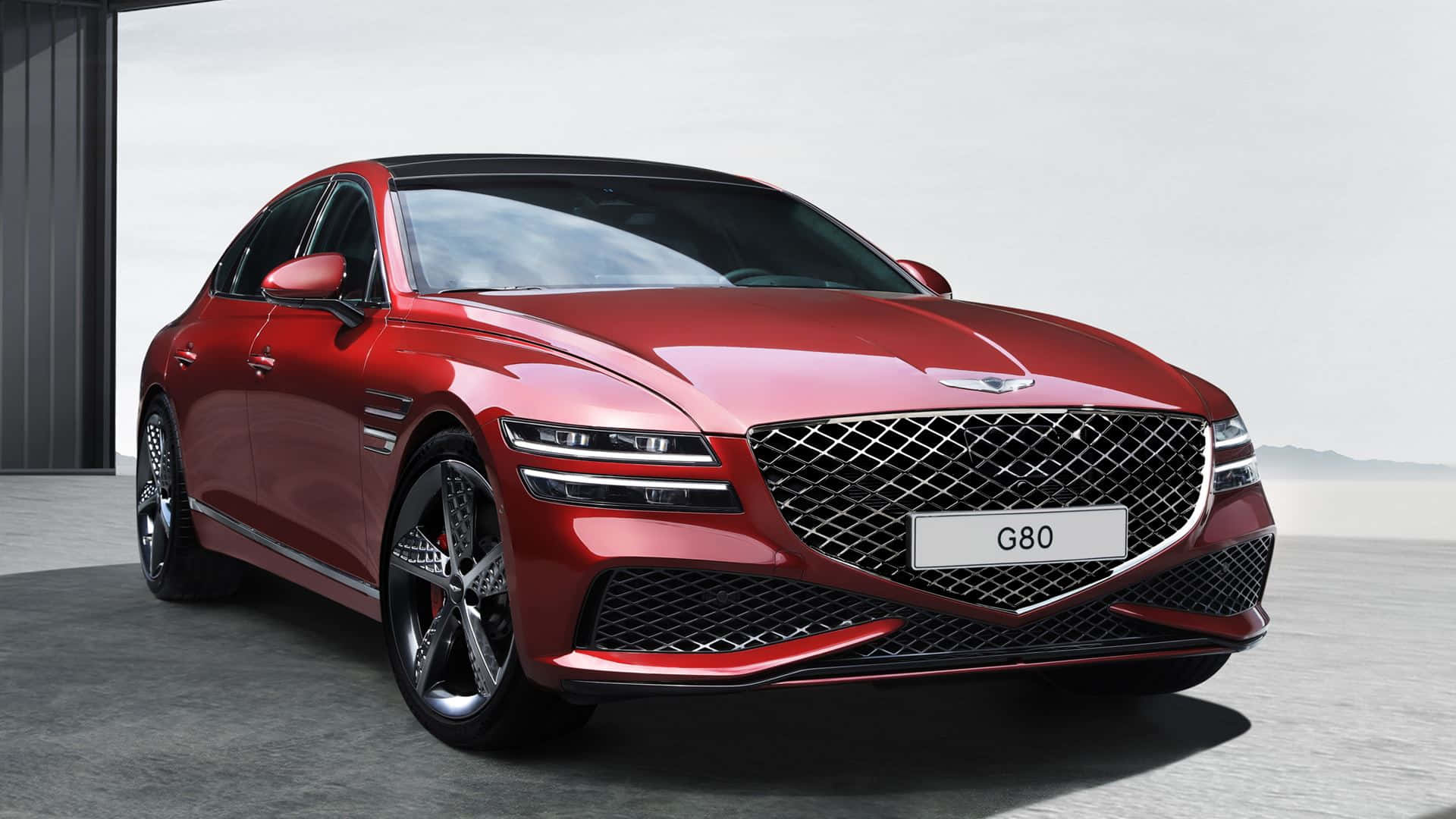 Genesis G80 桌布 壁紙 — 一輛時尚的紅色Genesis G80豪華轎車在簡約混凝土背景的攝影棚燈光下閃閃發光。