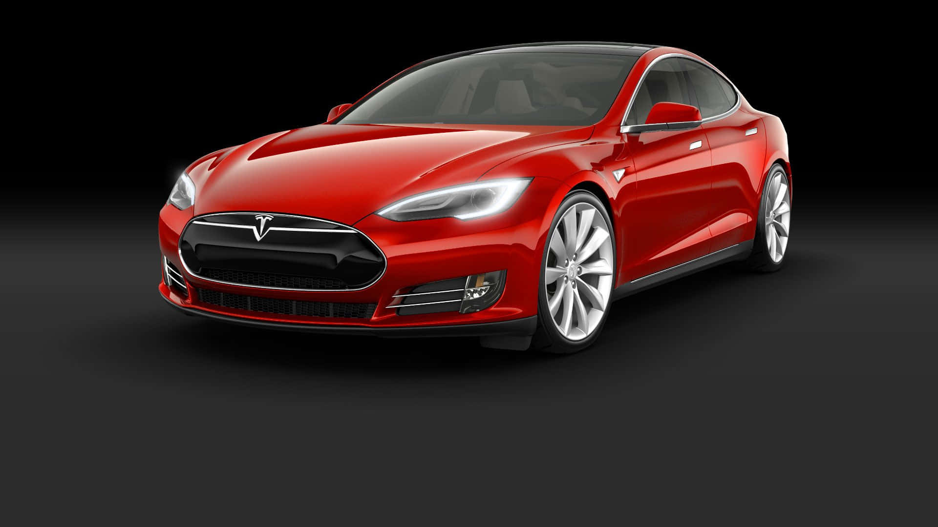 tesla 桌布 壁紙 — 一輛時尚的紅色Tesla Model S電動車在攝影棚燈光下，在深色漸變背景上閃閃發光。