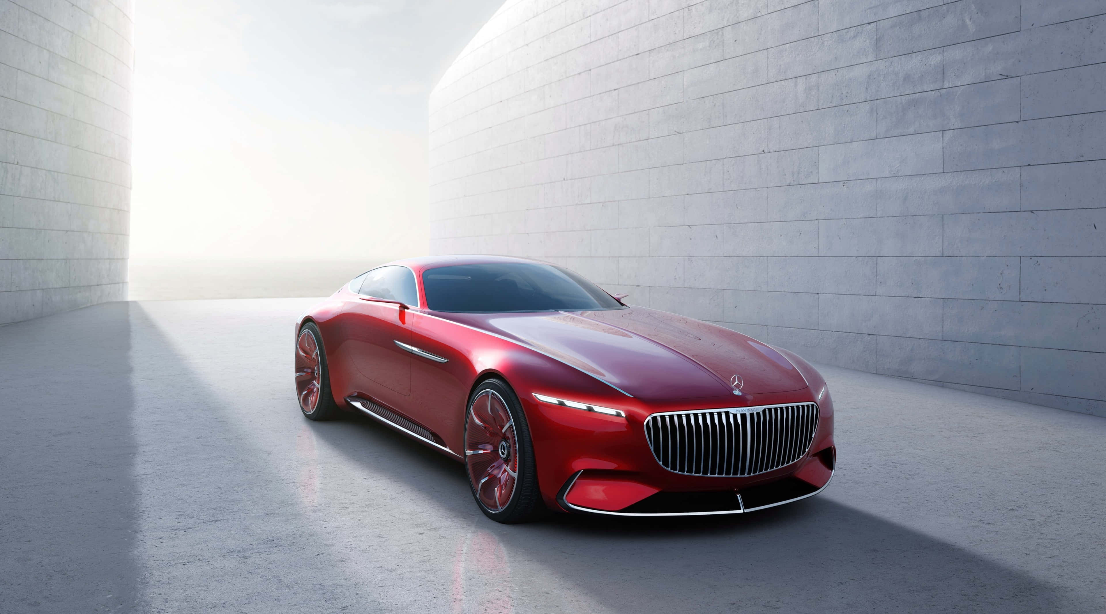 4K Mercedes 桌布 壁紙 — 一輛時尚的紅色豪華跑車在簡約混凝土走廊中，於柔和日光下閃耀。