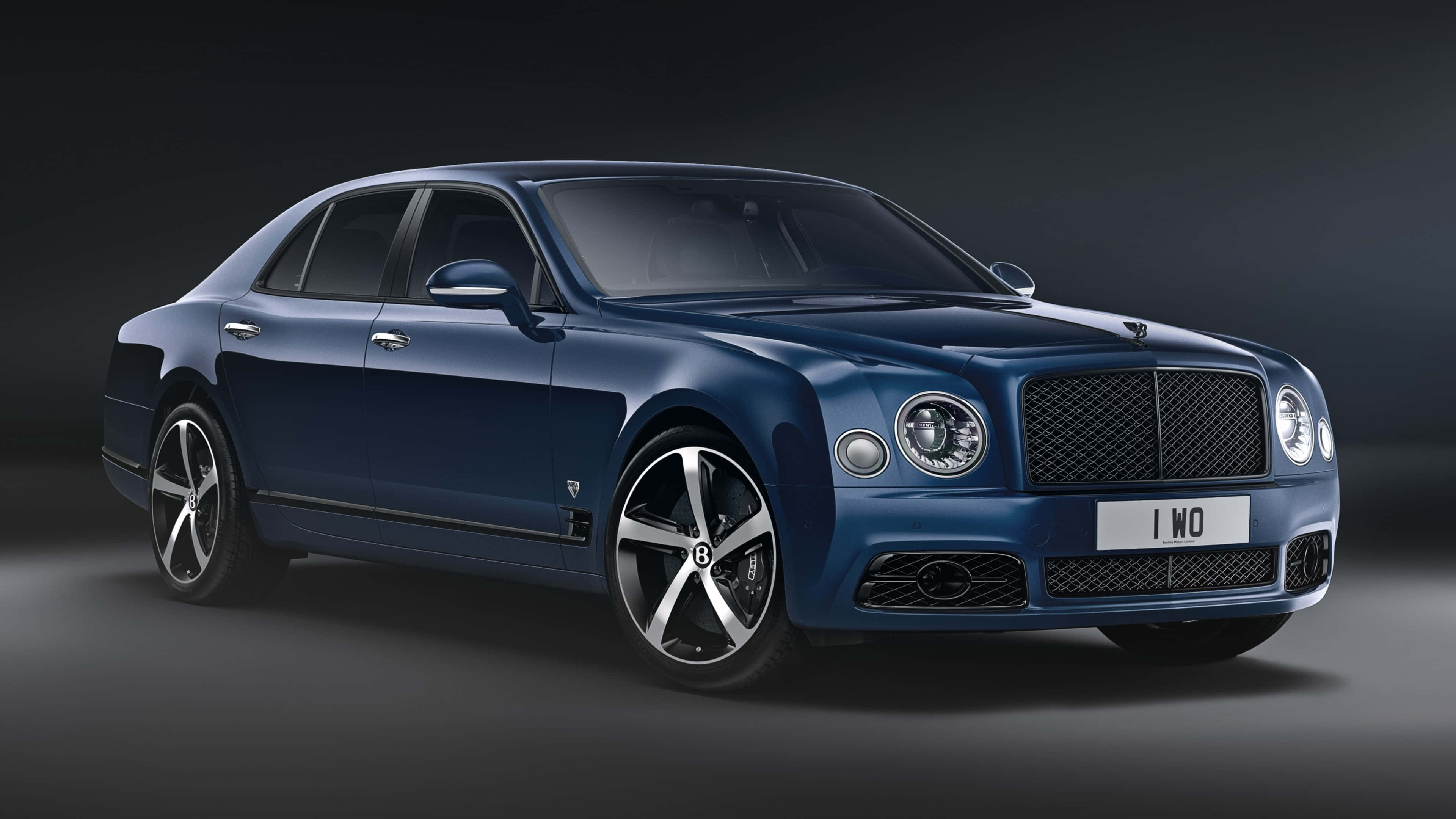 Bentley Mulsanne 桌布 壁紙 — 一輛時尚的藍色賓利Mulsanne轎車在攝影棚燈光下，在深色漸變背景上閃閃發光。