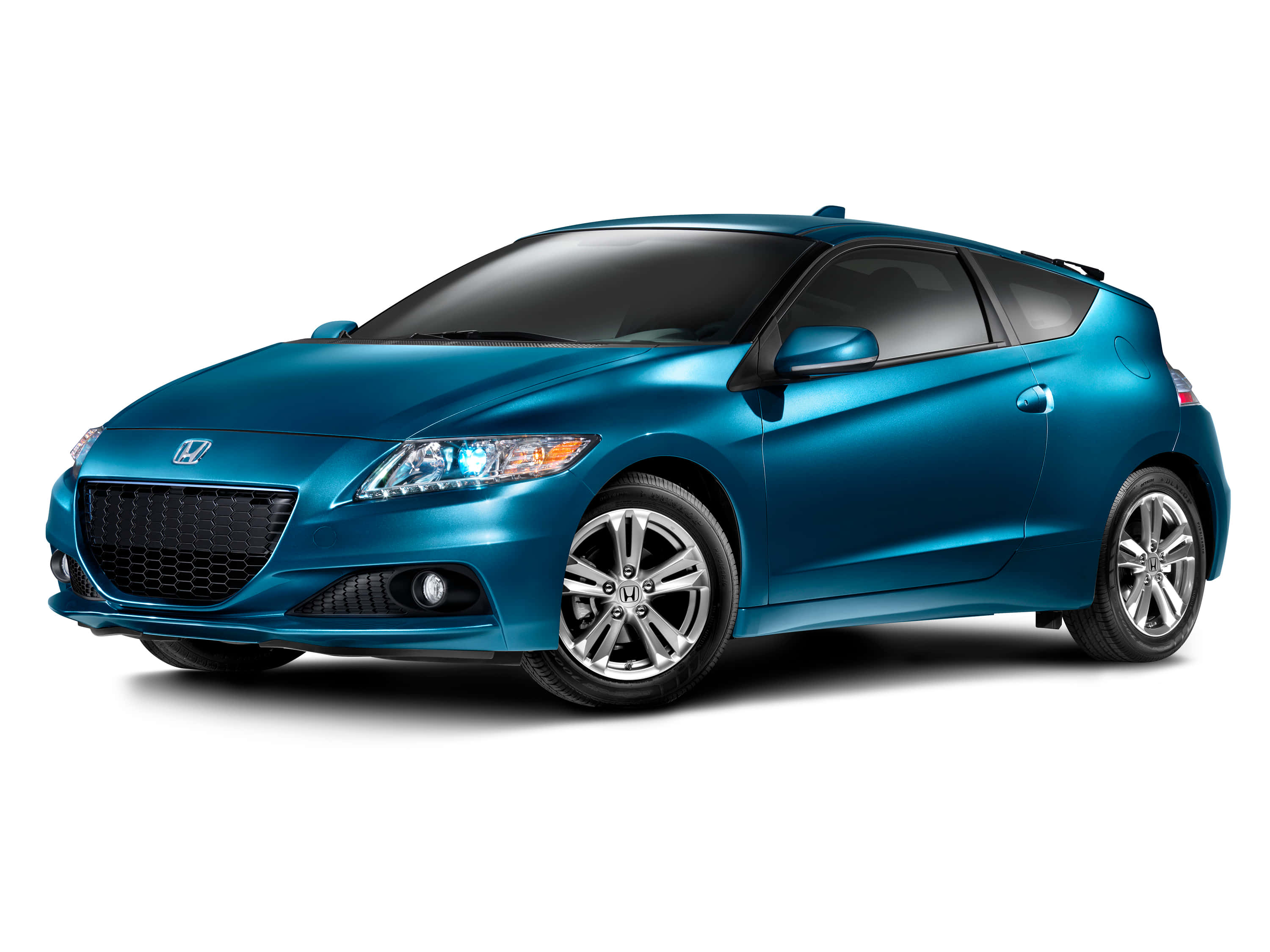 Honda Cr-z 桌布 壁紙 — 一輛時尚的金屬藍色本田CR-Z運動轎跑車，在攝影棚燈光下以潔白背景展示。