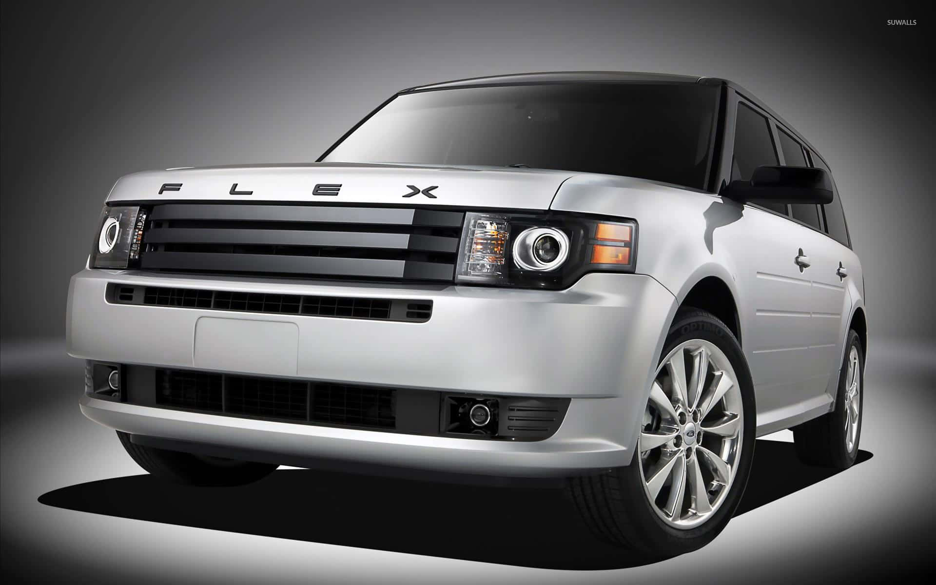 Ford Flex 桌布 壁紙 — 一輛時尚的銀色Ford Flex SUV在攝影棚中展示，配有戲劇性燈光和深色漸變背景。