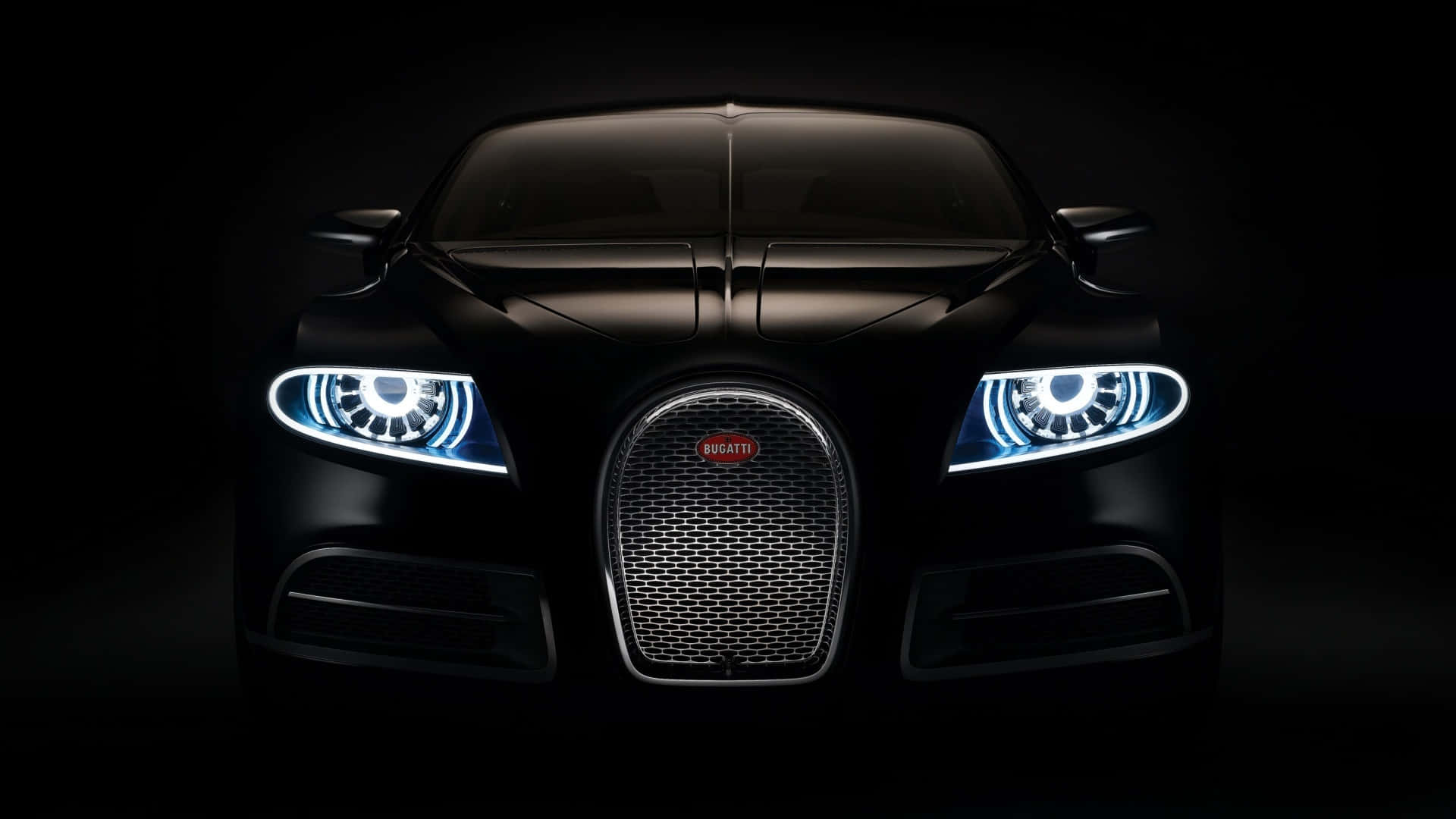 HD Car 桌布 壁紙 — 一輛時尚的黑色Bugatti超級跑車在漆黑的攝影棚背景下發出明亮的藍色車頭燈光。