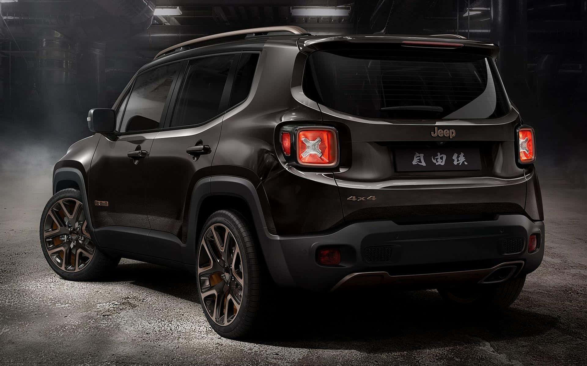 Jeep Renegade 桌布 壁紙 — 一輛時尚的黑色Jeep Renegade 4x4 SUV在昏暗的工業車庫中從後方展示，帶有戲劇性的煙霧效果。