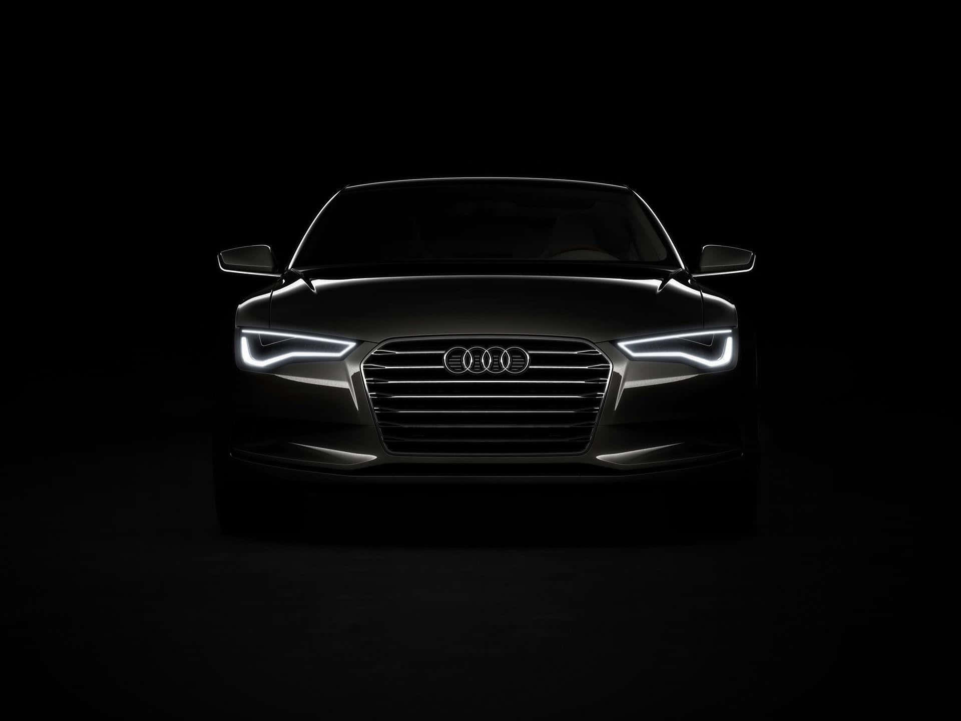 Black And White Car 桌布 壁紙 — 一輛時尚的黑色奧迪汽車在漆黑的攝影棚背景下，散發出銳利的白色頭燈光芒。