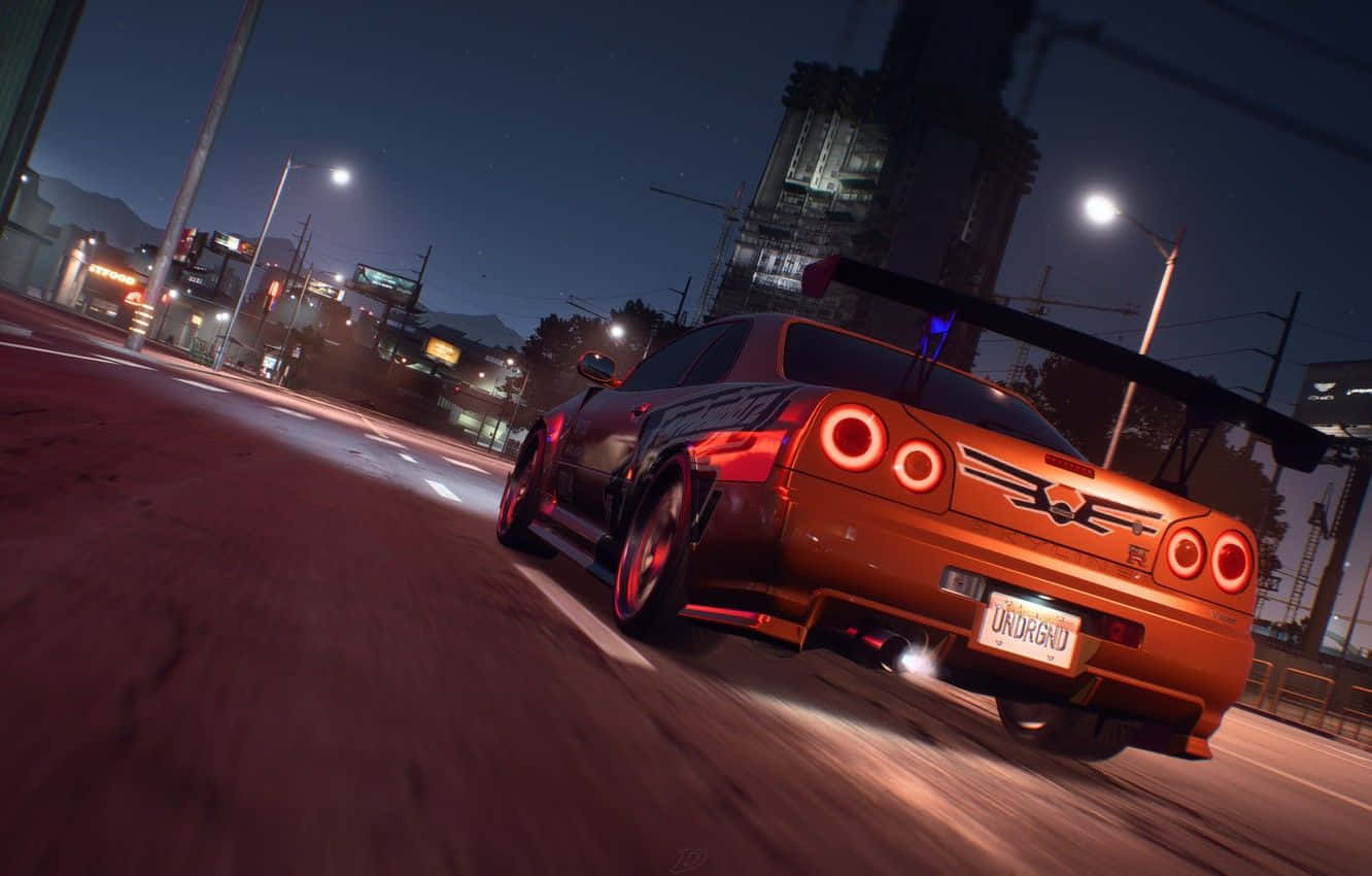 一輛汽車在夜晚的街道上行駛 壁紙