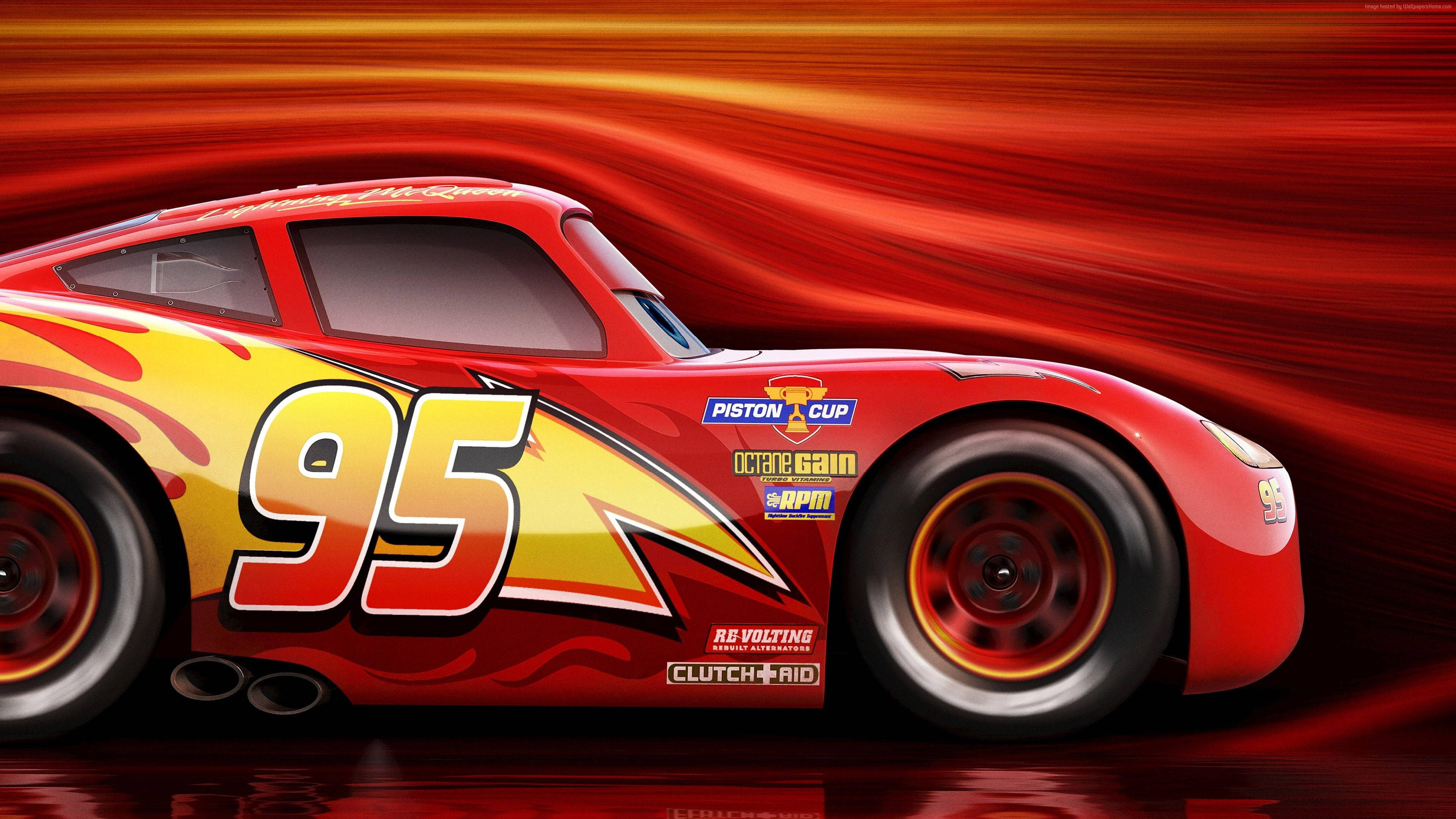 Disney Cars 桌布 壁紙 — 一輛紅色賽車，編號95，在熾熱的橙色和紅色動態模糊背景中疾馳。