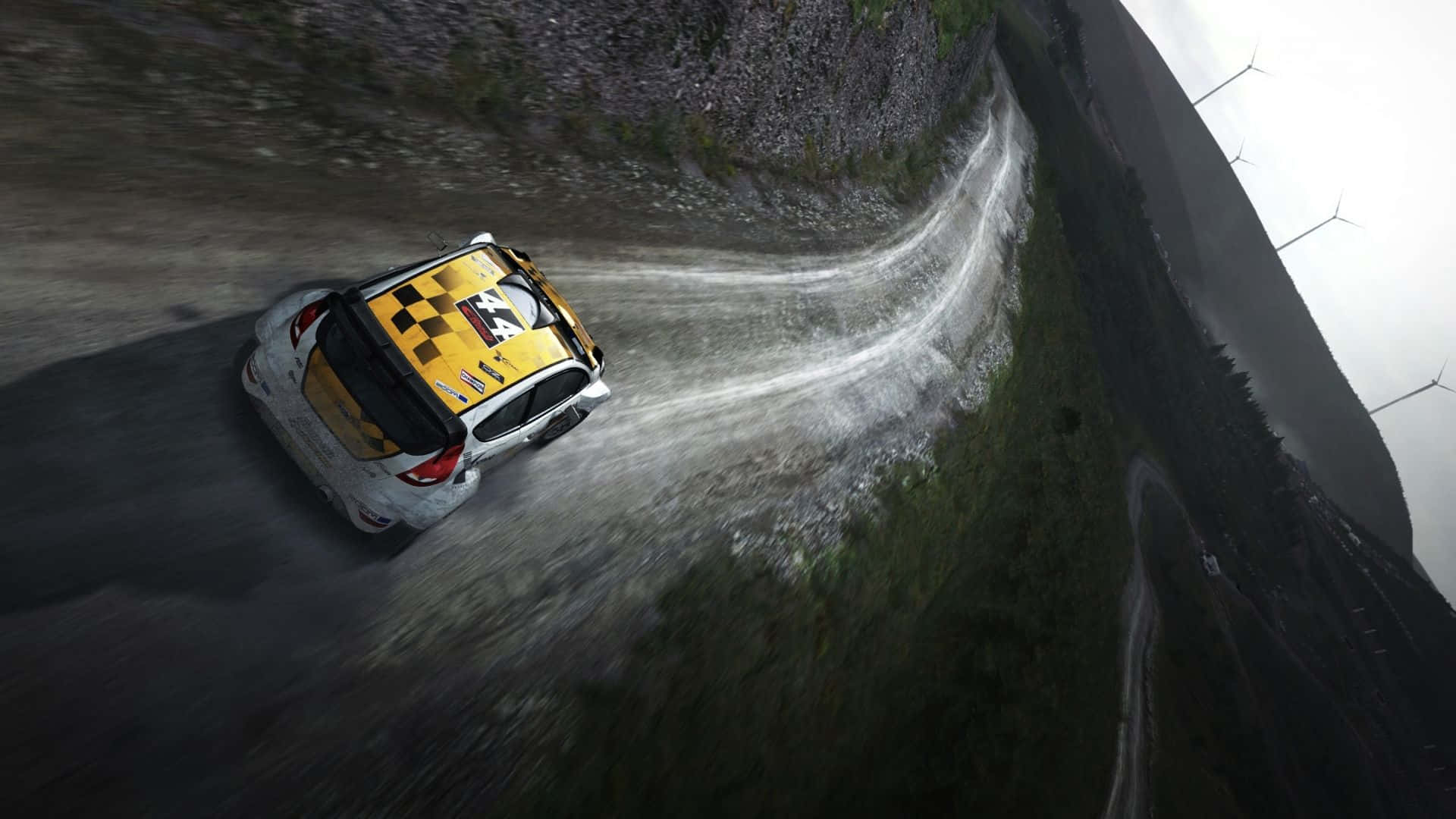一輛黃色拉力賽車在泥路上飛馳 壁紙