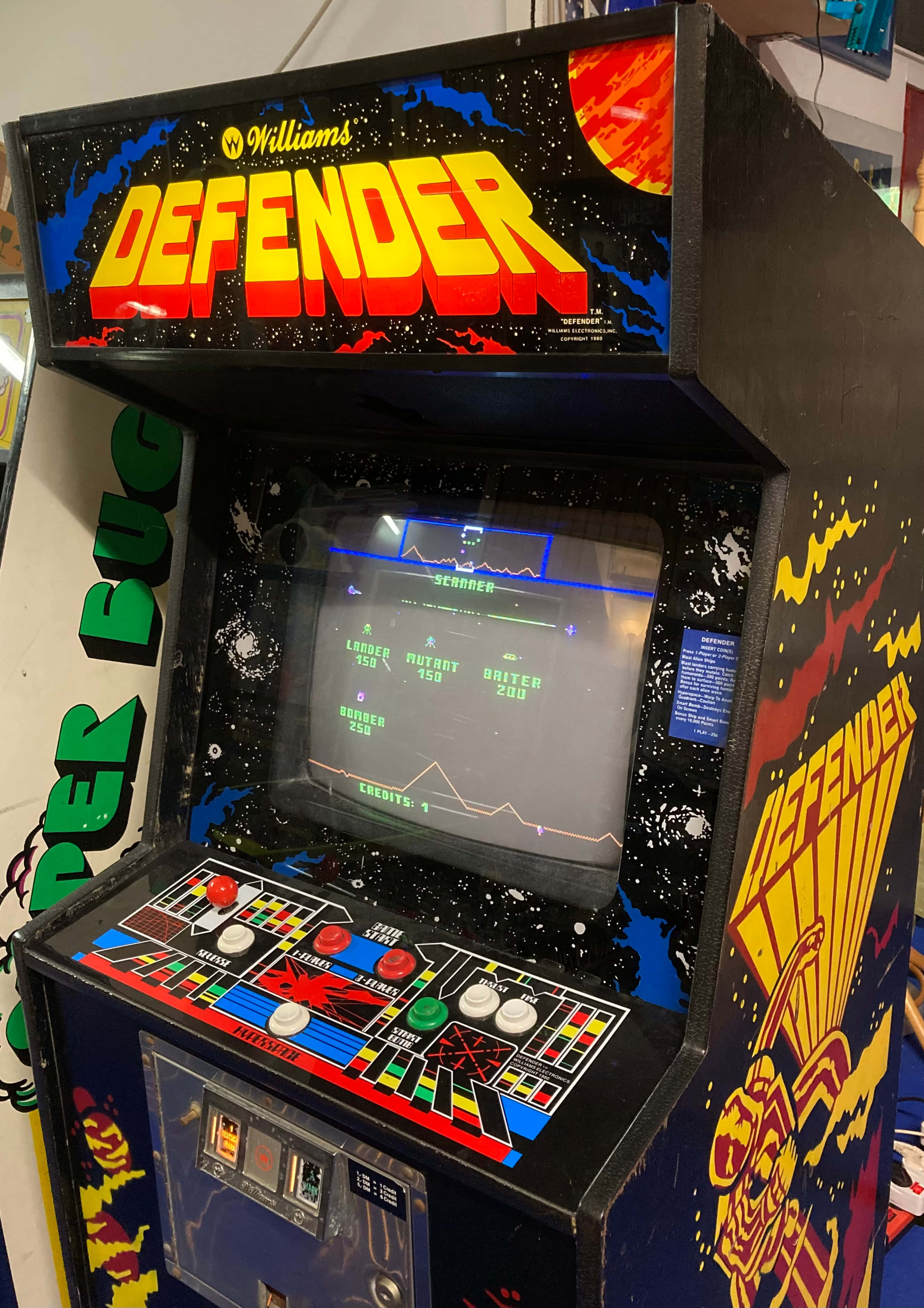 Arcade Games 桌布 壁紙 — 一部復古Williams Defender街機，帶有發光螢幕和色彩繽紛的控制面板。