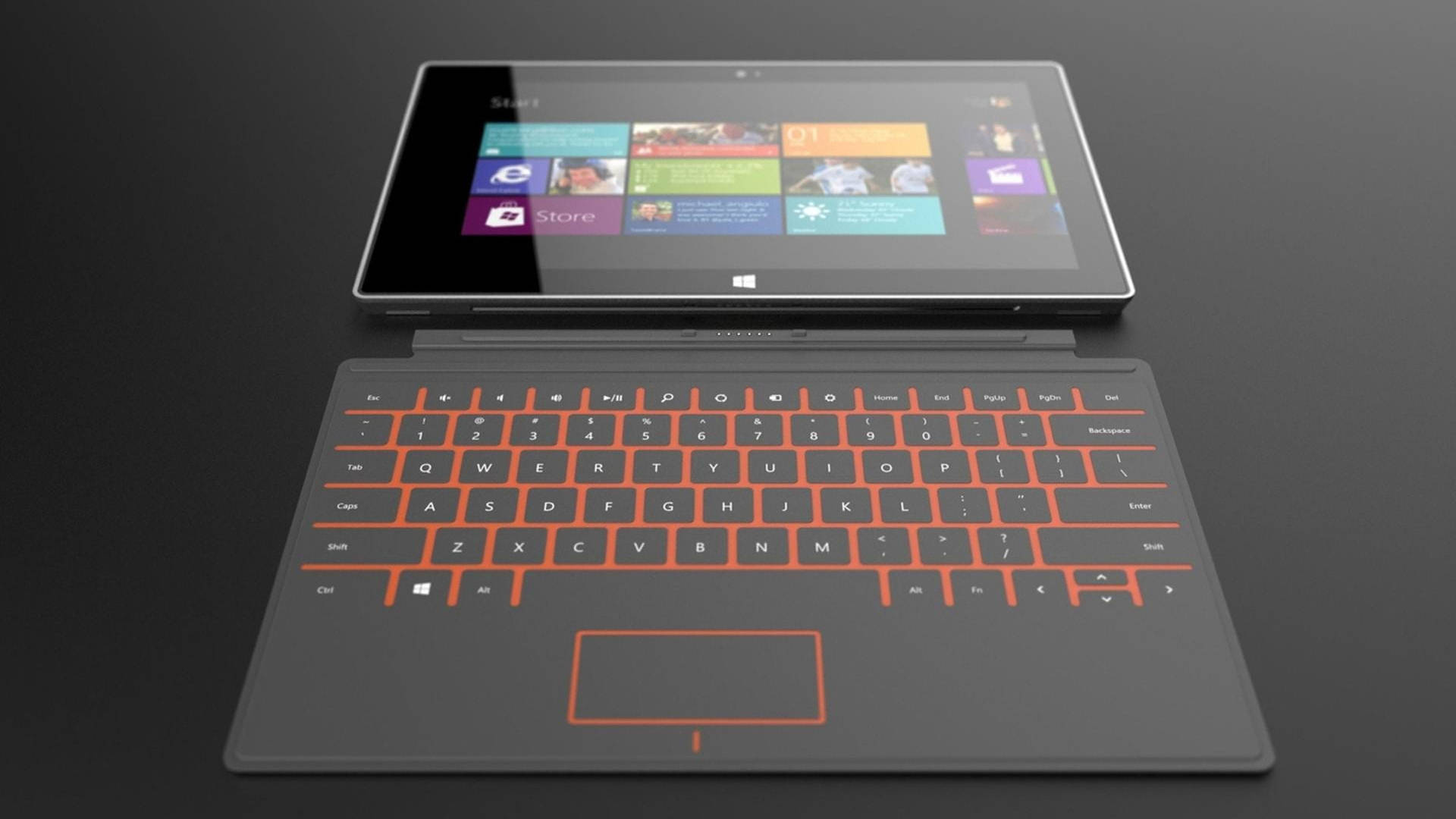 microsoft 桌布 壁紙 — 一部時尚平板電腦配以鮮橙色鍵盤底座，在深色表面上顯示 Windows 開始畫面。