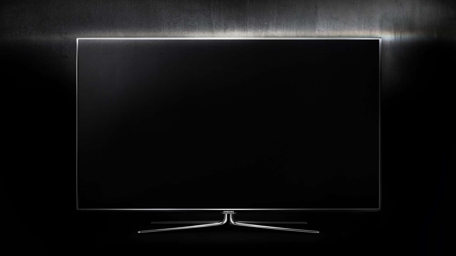 Television Set 桌布 壁紙 — 一部時尚現代電視，黑色屏幕和銀色支架，在深色紋理牆壁上由發光燈條照亮。