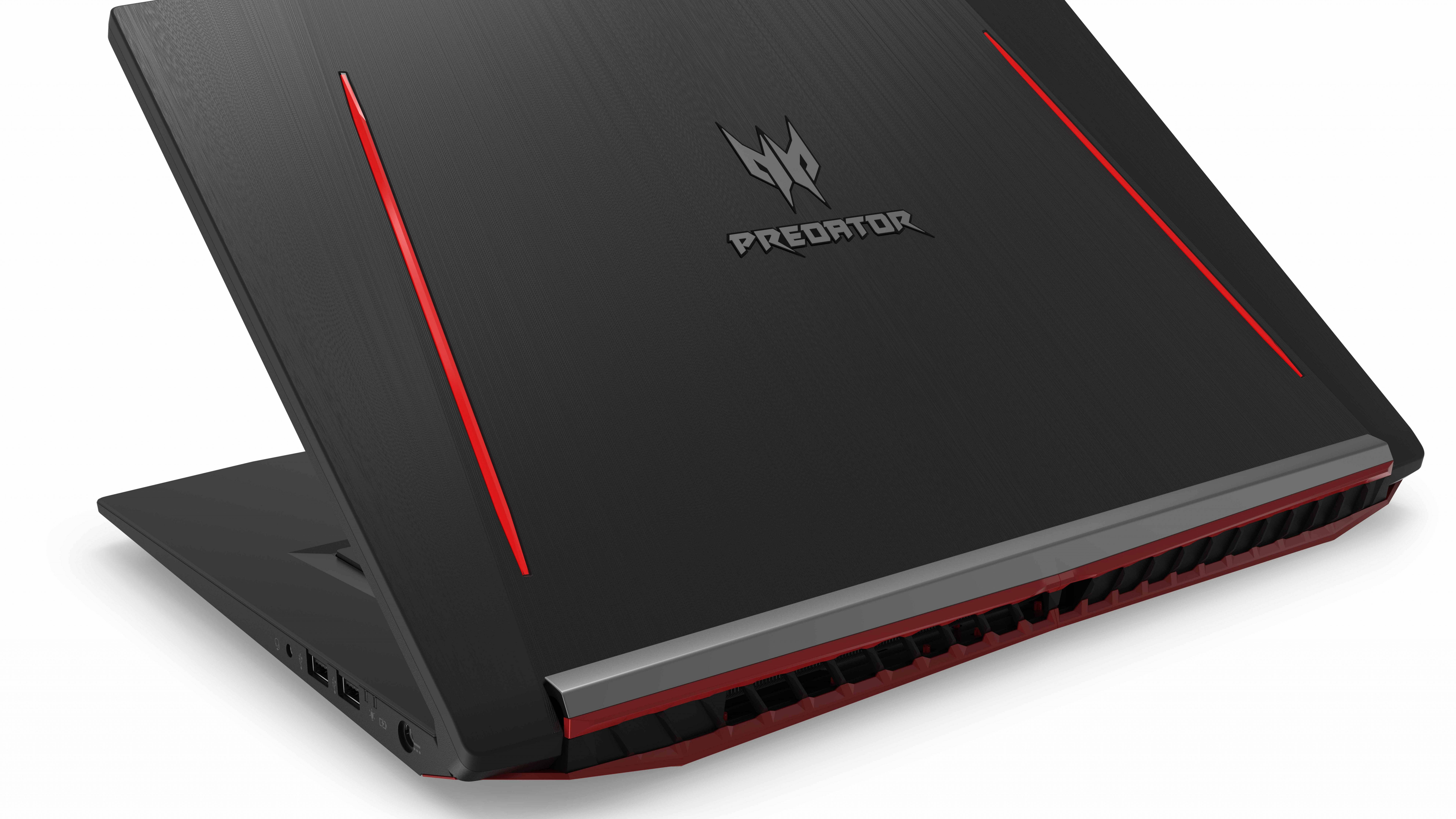Laptop 桌布 壁紙 — 一部時尚的黑色 Acer Predator 電競手提電腦，帶有鮮明的紅色點綴和棱角設計，置於純白背景上。