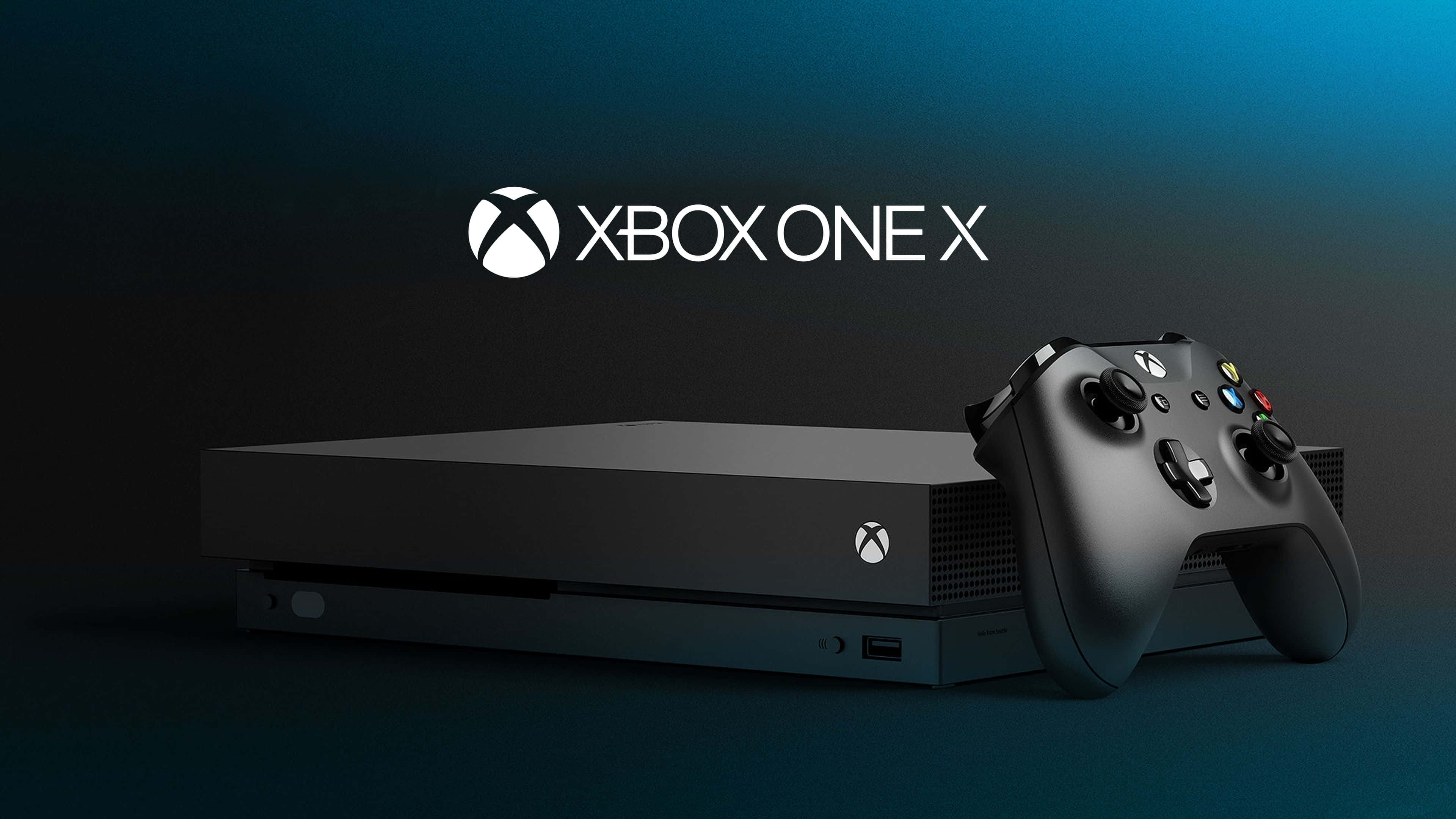 4K Gaming Consoles 桌布 壁紙 — 一部時尚的黑色 Xbox One X 主機和控制器，放置在帶有發光標誌的漸變藍色背景上。